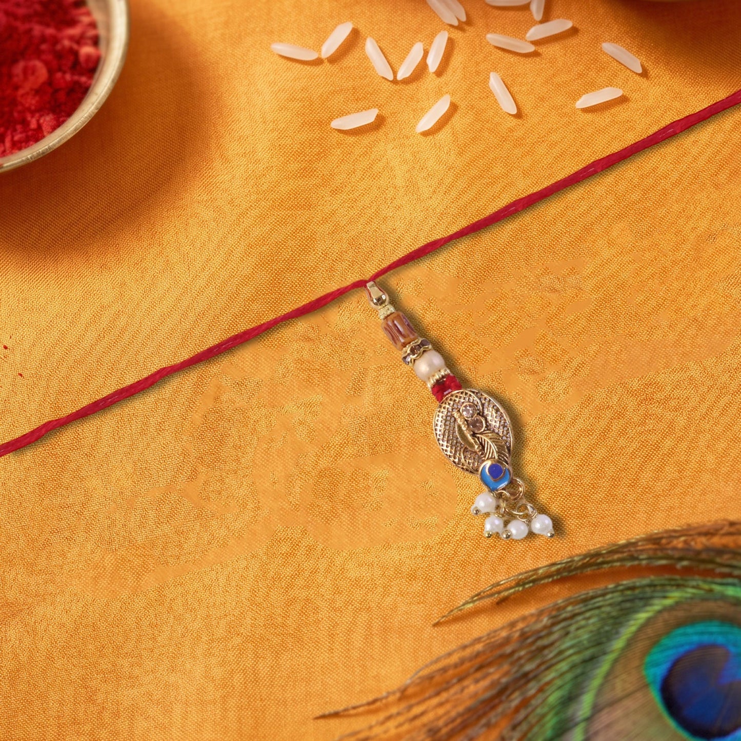 Close-up of Blue Stone Bhabhi Rakhi showing pearl cluster latkan