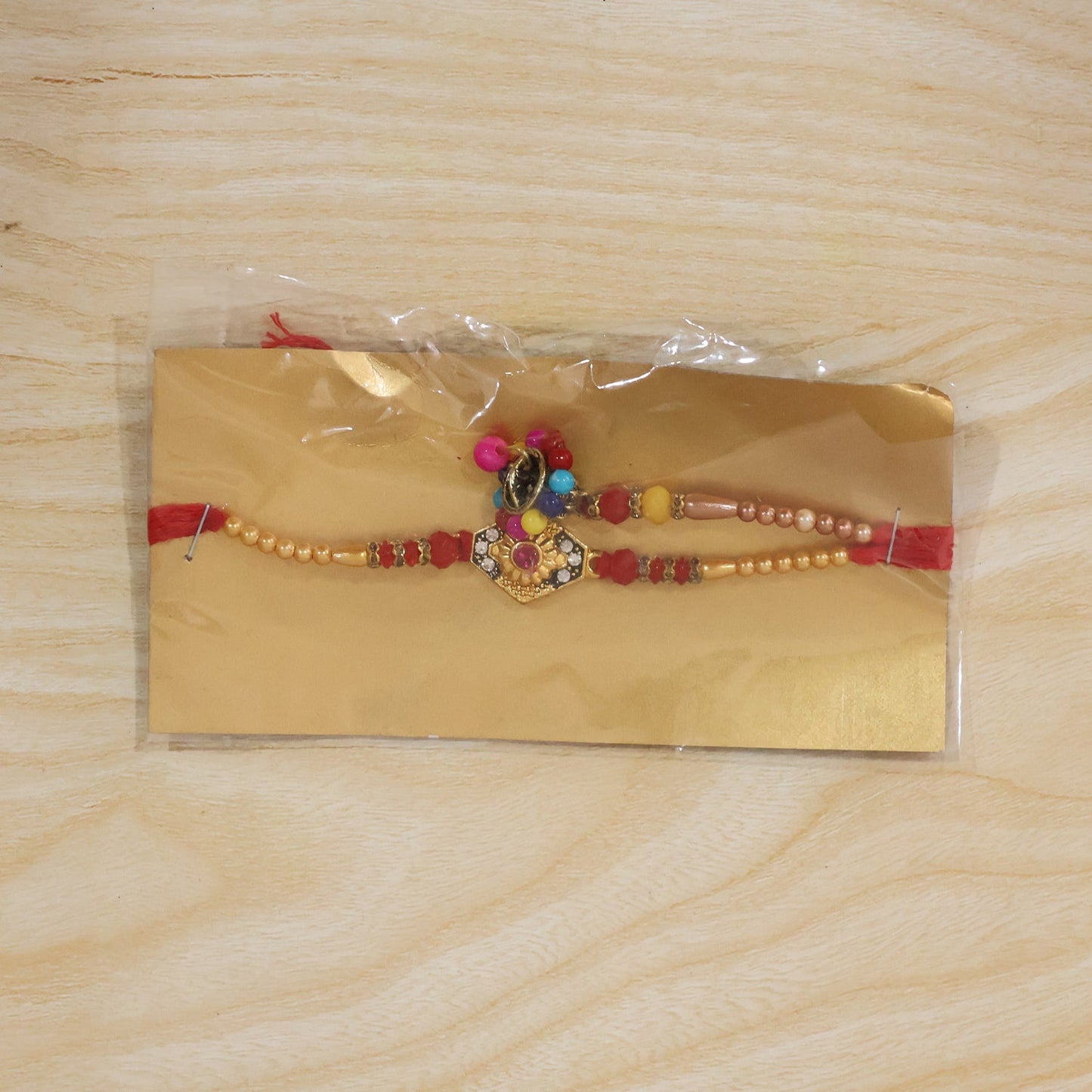 Close-up of colorful beads and thread on Hexagon Stone Designer Rakhi
