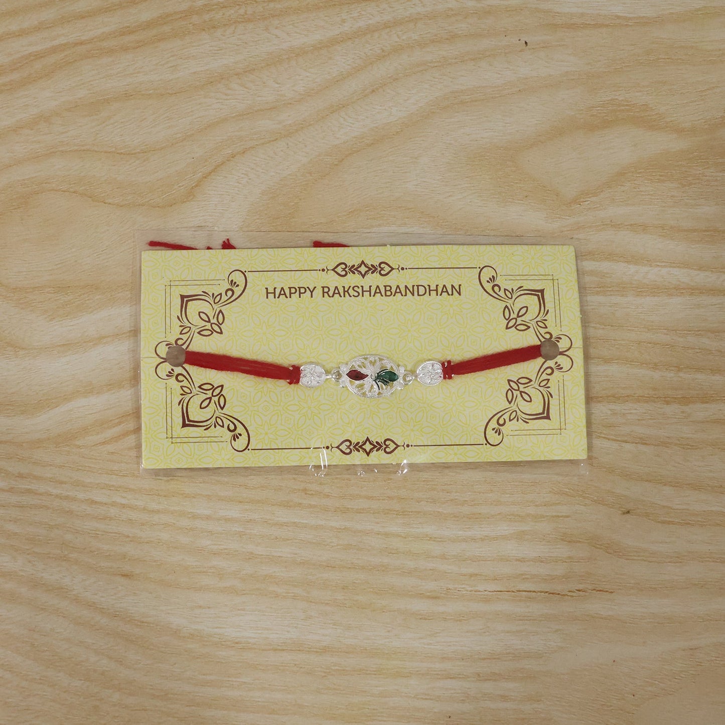 Silver Oval Design Rakhi with Red Thread (1 Pc)