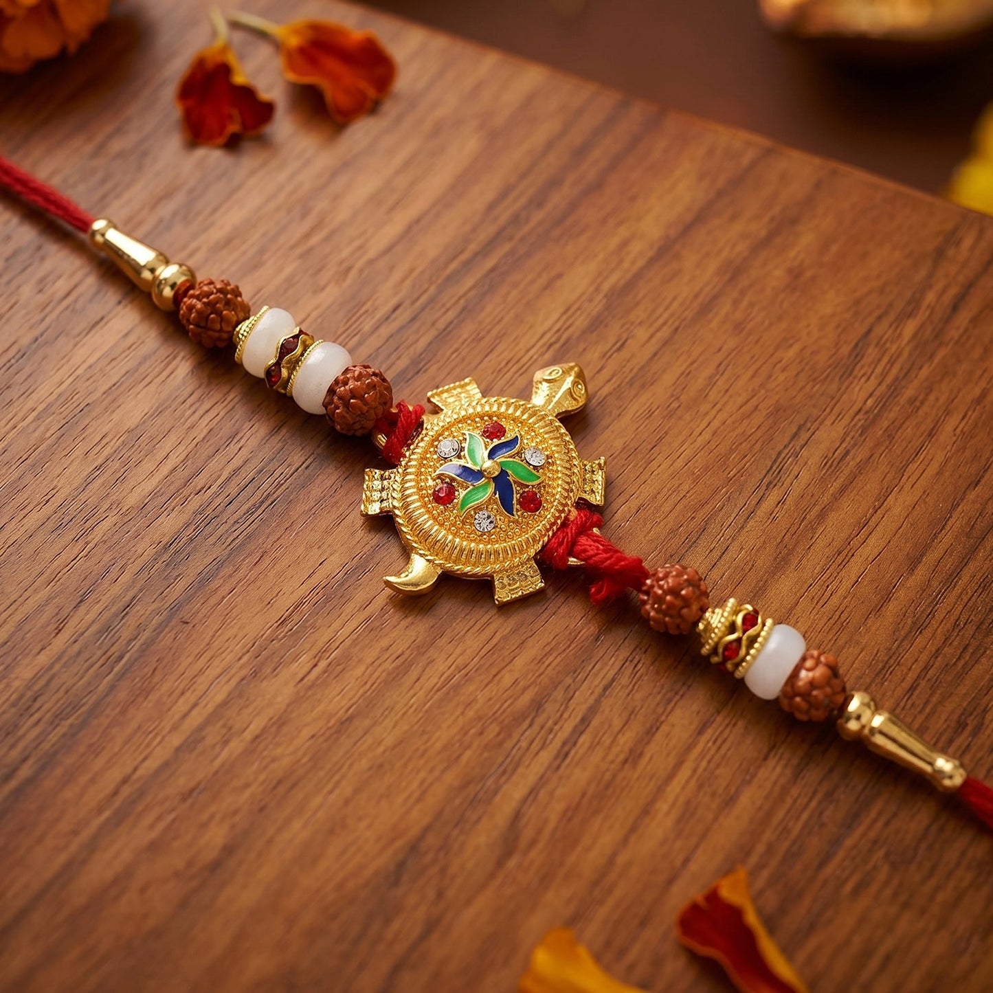 Close-up of turtle centerpiece and decorative Rudraksha beads on Rakhi