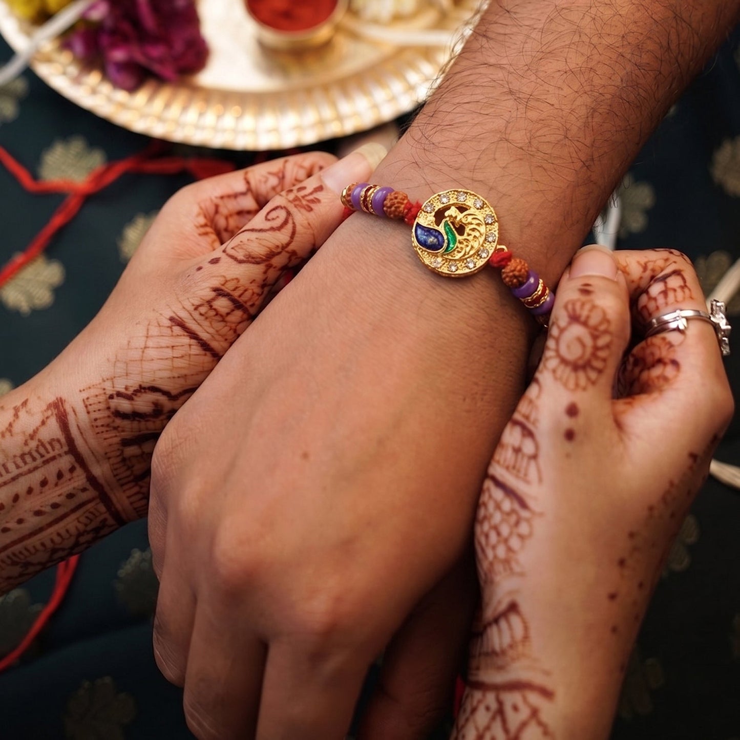 Peacock Design Rakhi displayed on white background