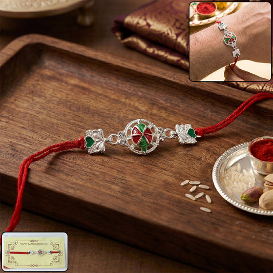 Silver floral design Rakhi with red thread - front view