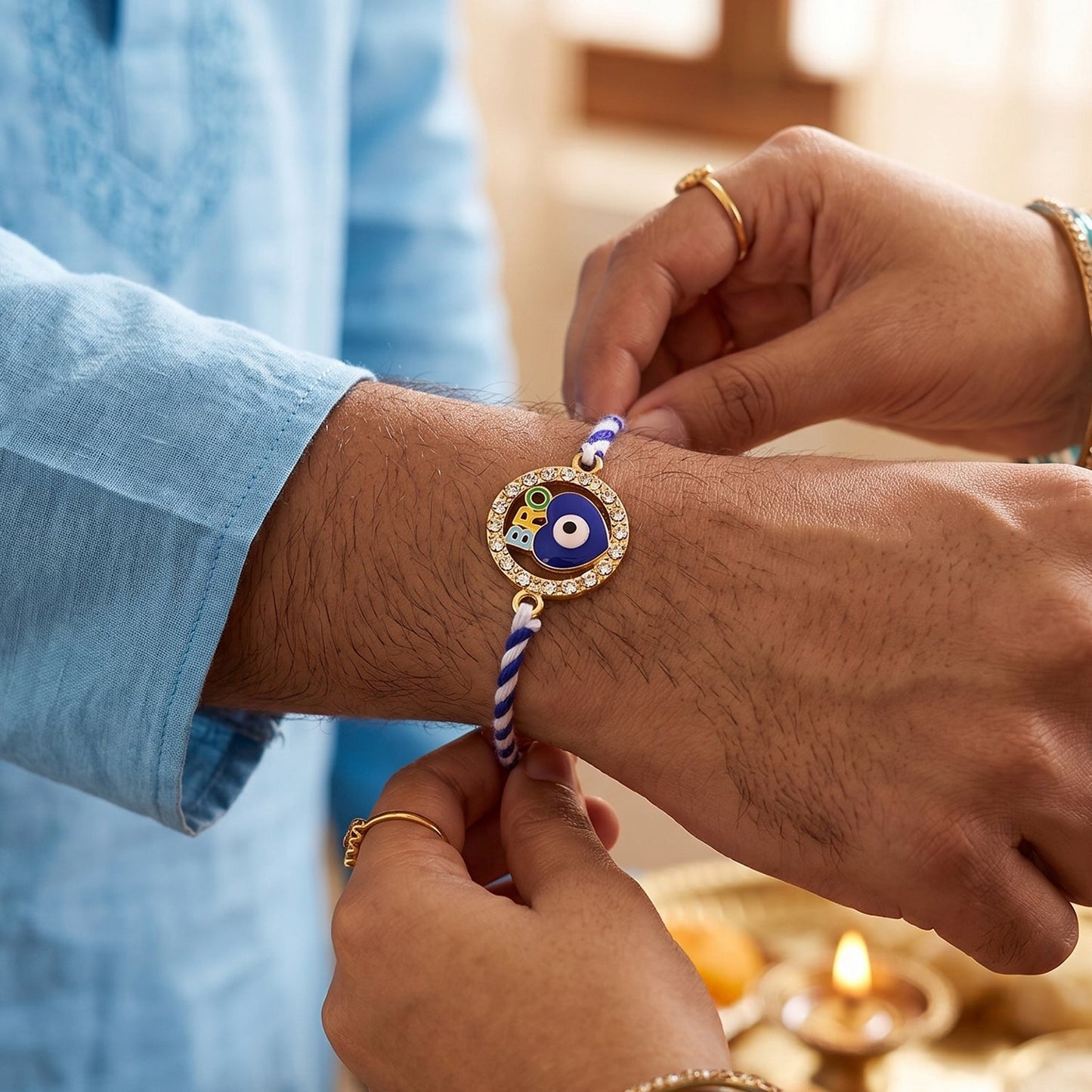 Close-up of blue evil eye and decorative beads on fancy dori rakhi