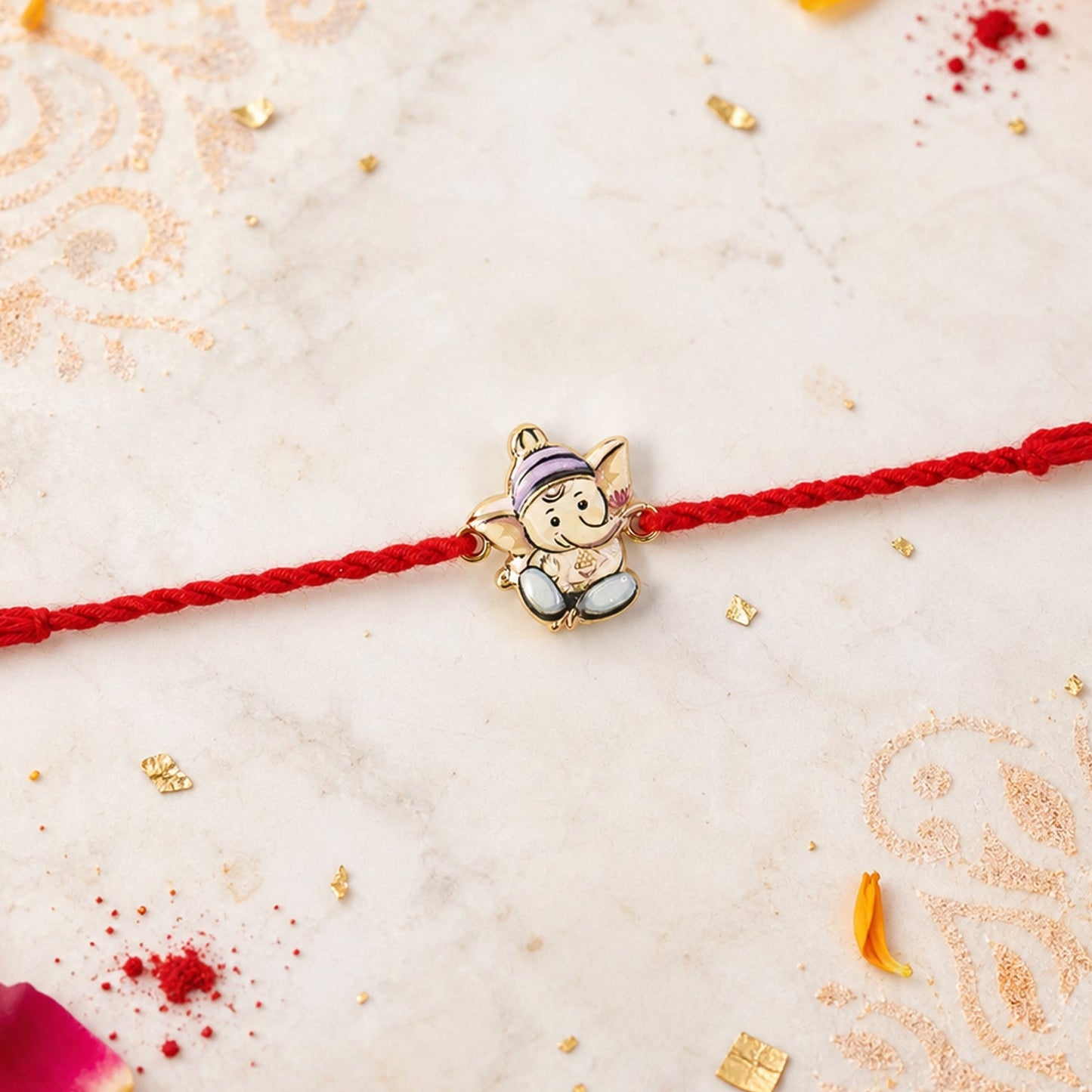 Ganesh rakhi tied on wrist with intricate thread design