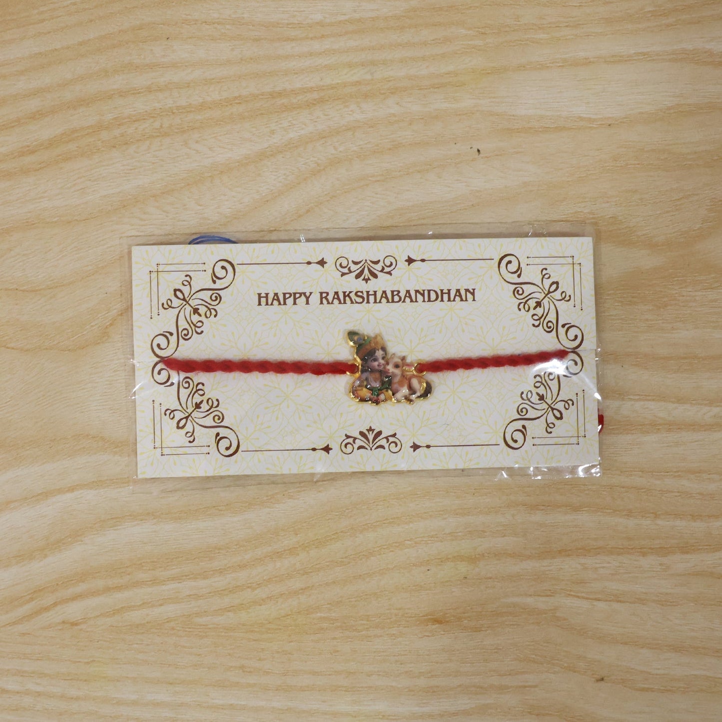 Bal Krishna with Cow Fancy Dori Rakhi packaging view