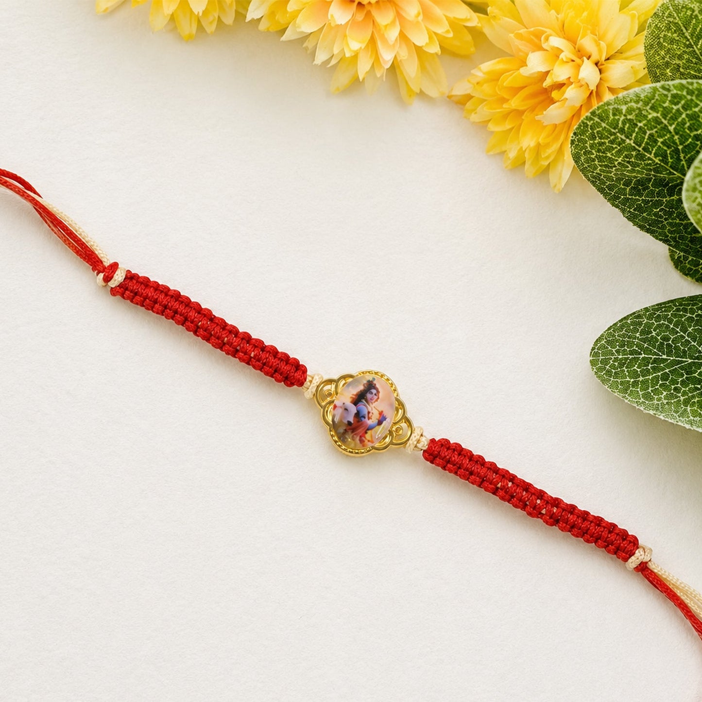 Close up of Krishna Cow Charm on Fancy Dori Rakhi