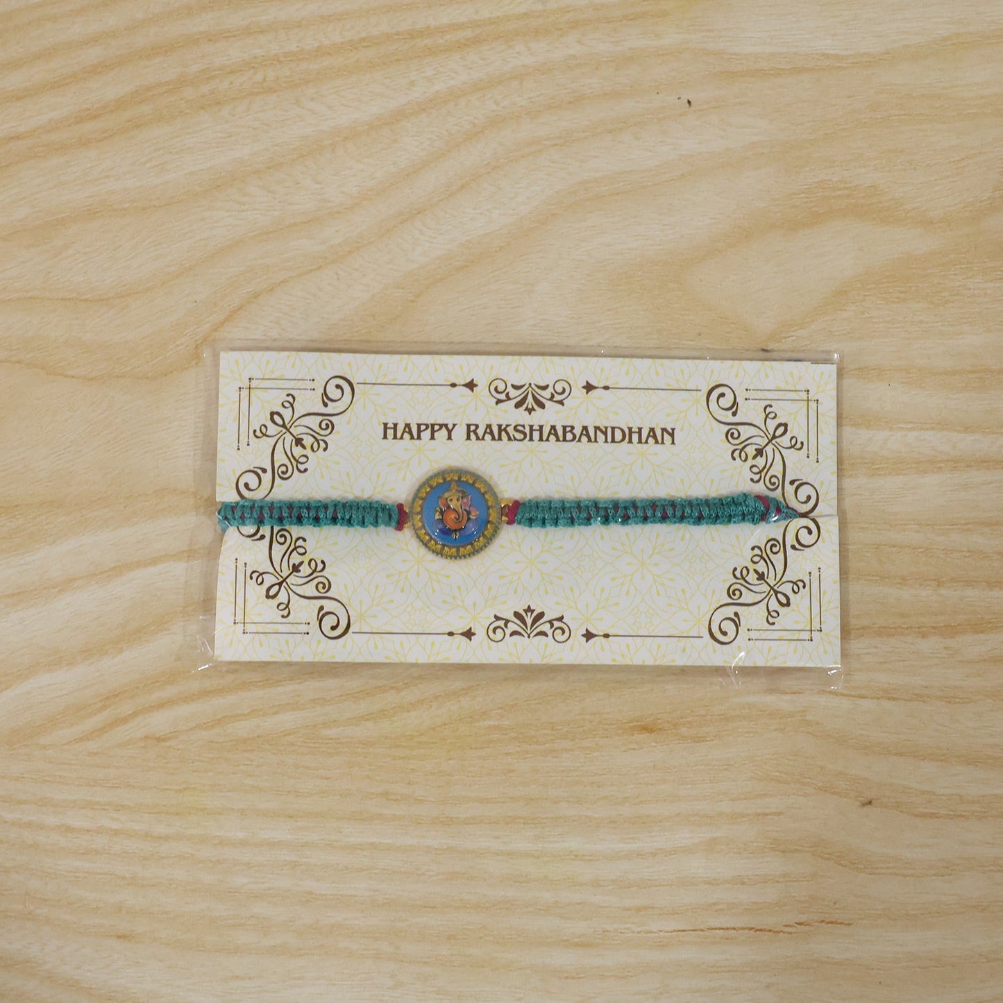 Elegant Ganesh charm with festive rakhi thread