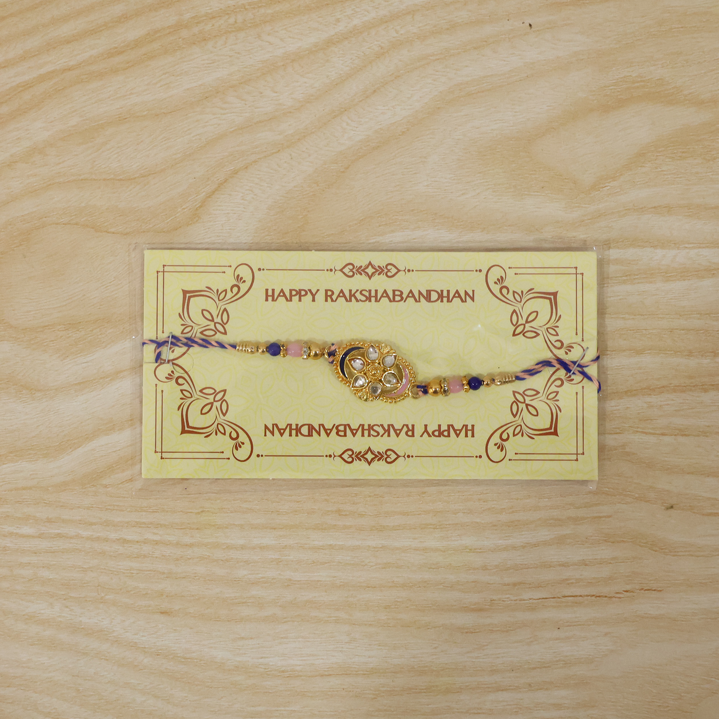 Designer rakhi showing detailed floral oval charm