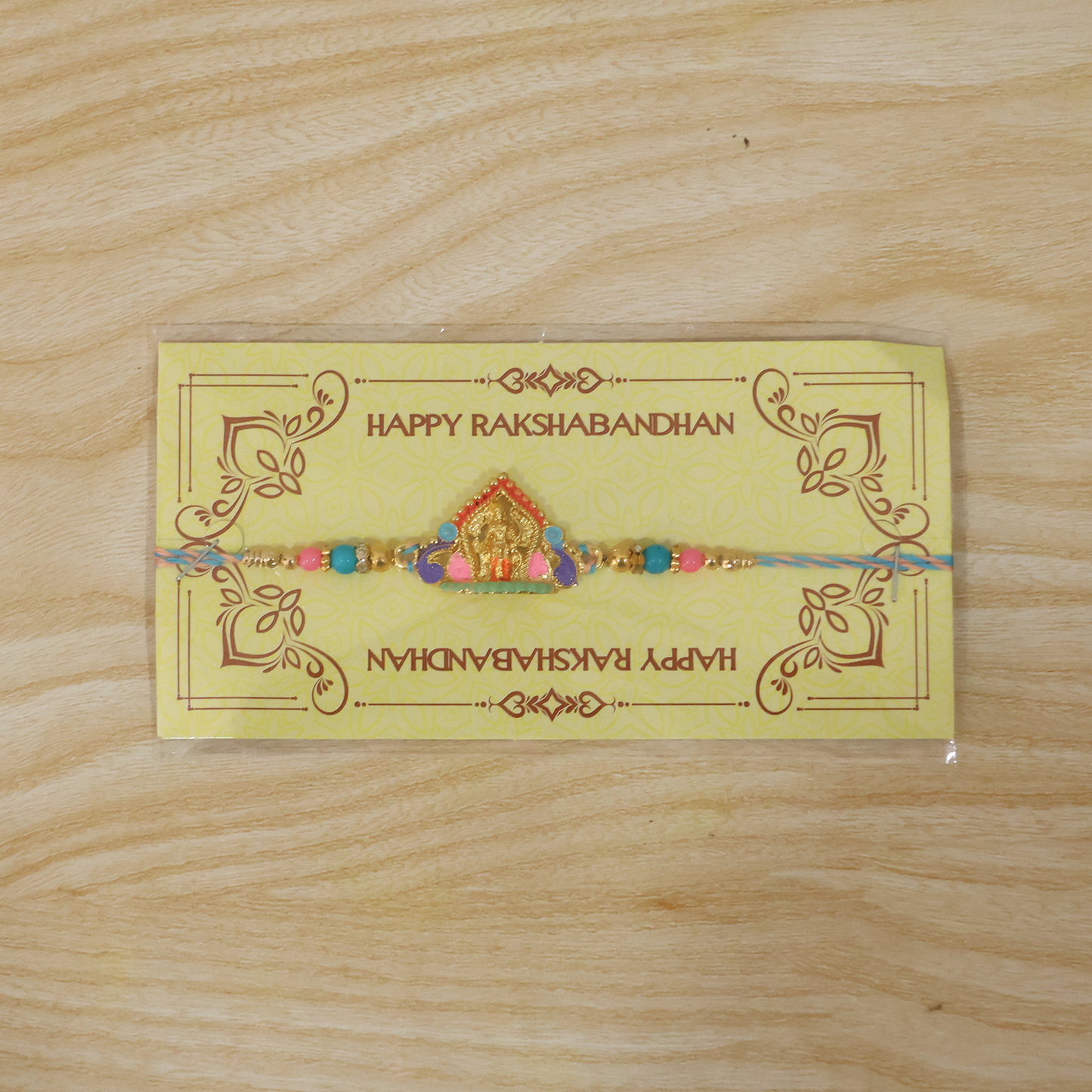 Designer Rakhi with idol charm and vibrant beads