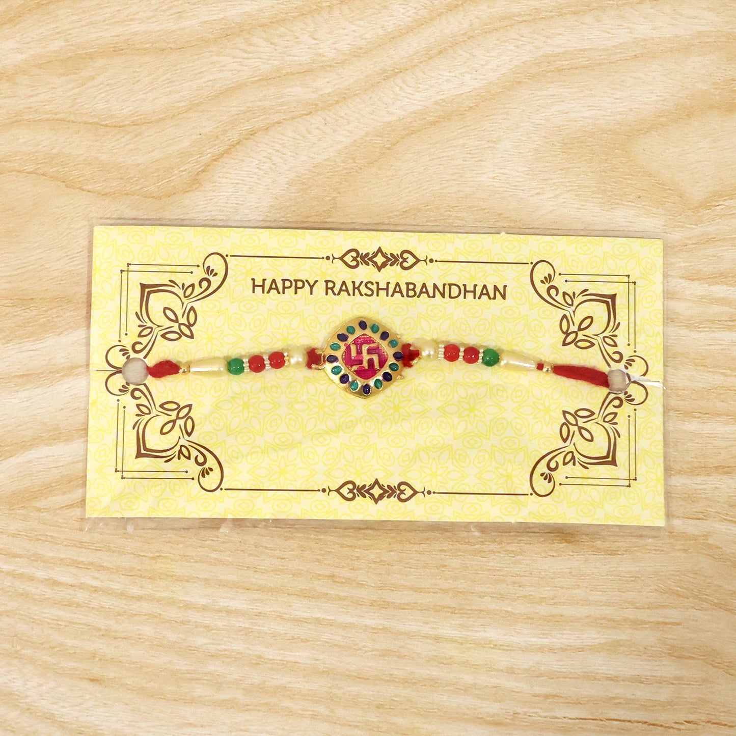 Traditional Raksha Bandhan rakhi showing swastik charm and beads