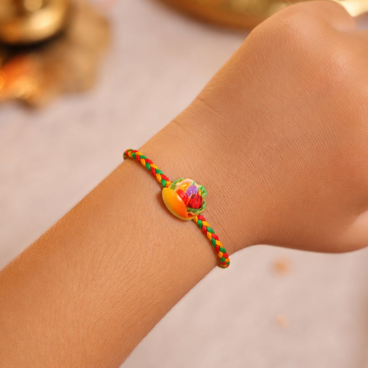 Detailed close-up of colorful fruit design on rakhi