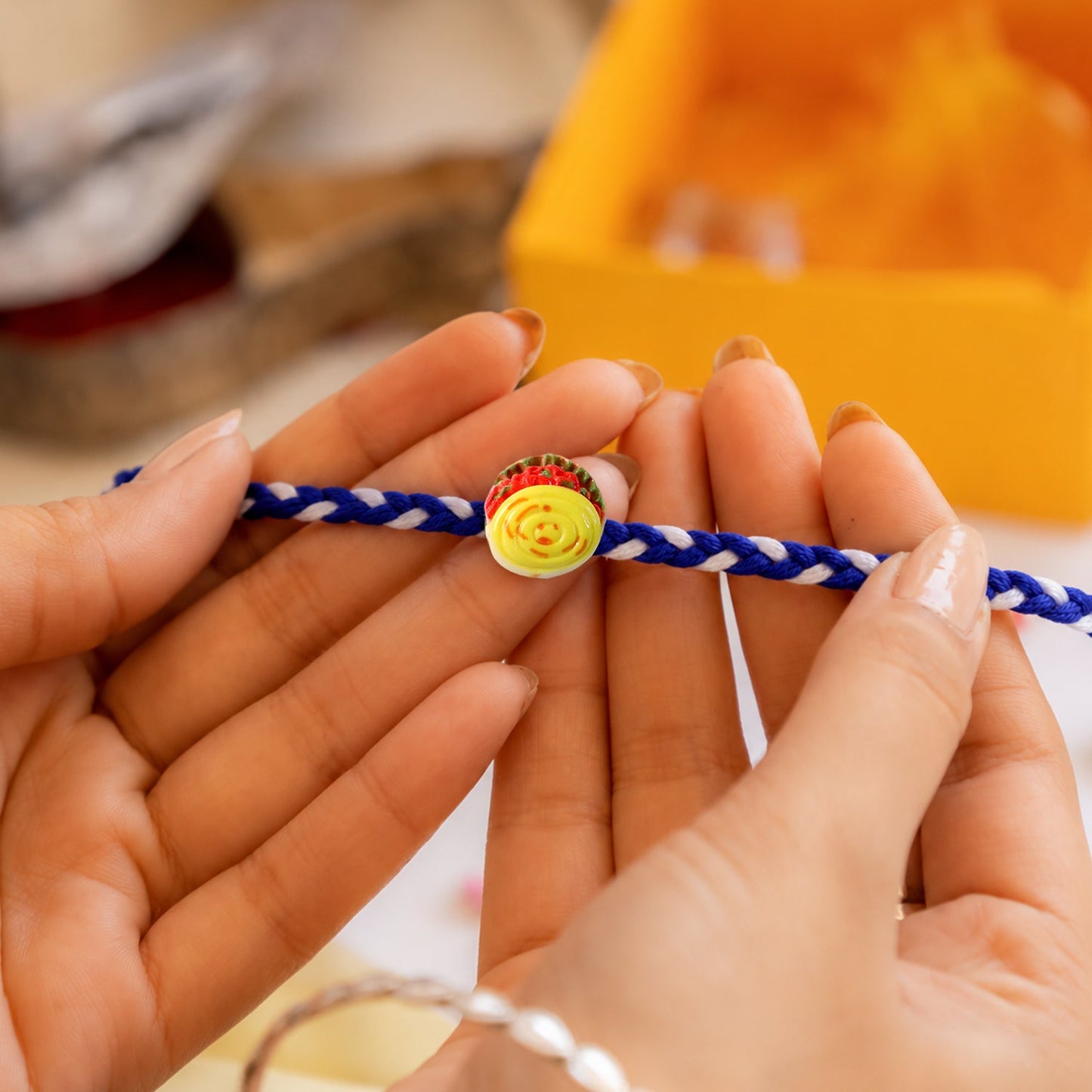 Close up of designer threads on Yellow Sweet Dessert Fancy Dori Rakhi