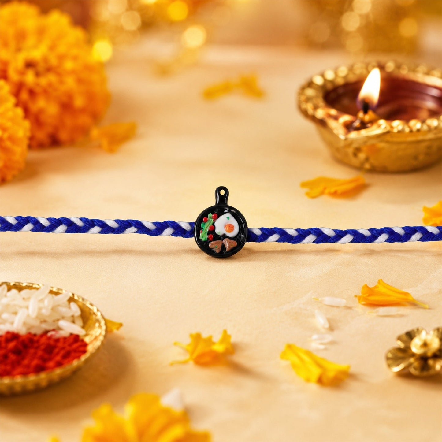Close-up of Mini Frying Pan Fancy Dori Rakhi thread detail