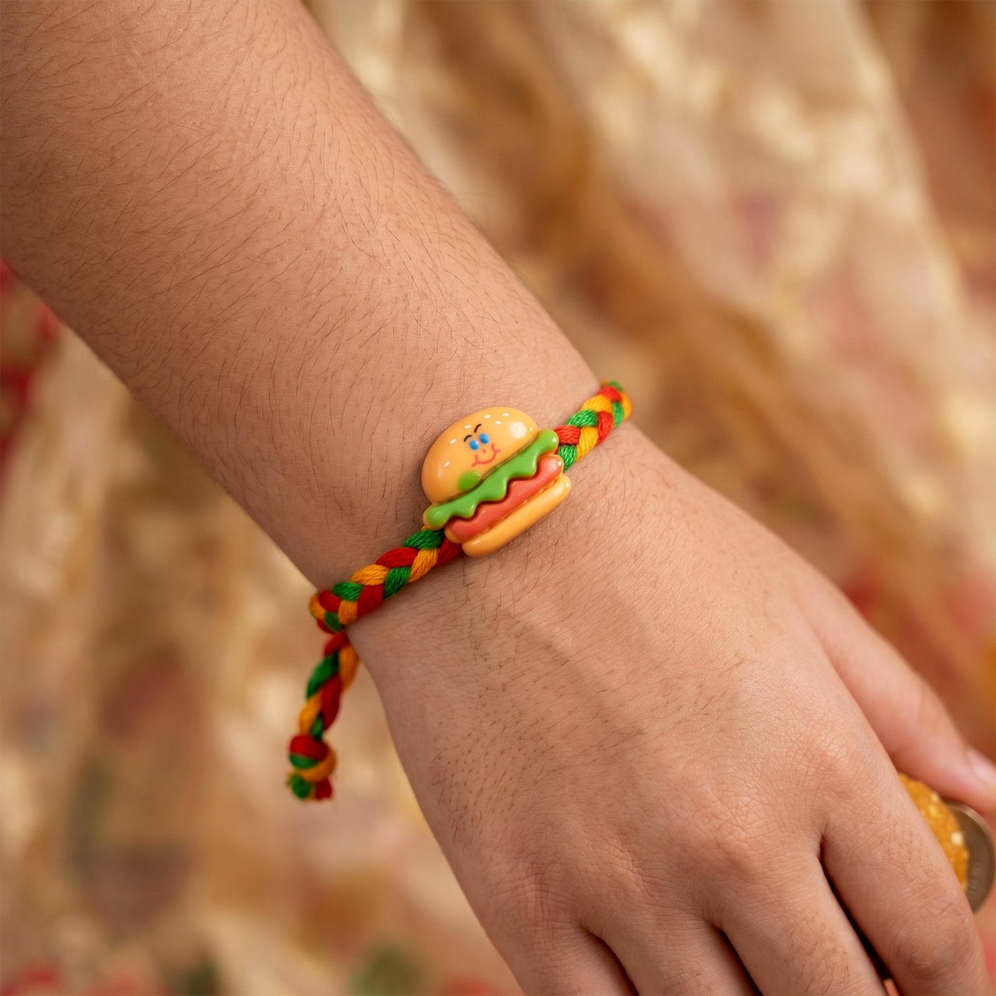 Side angle of Cute Burger Charm Fancy Dori Rakhi