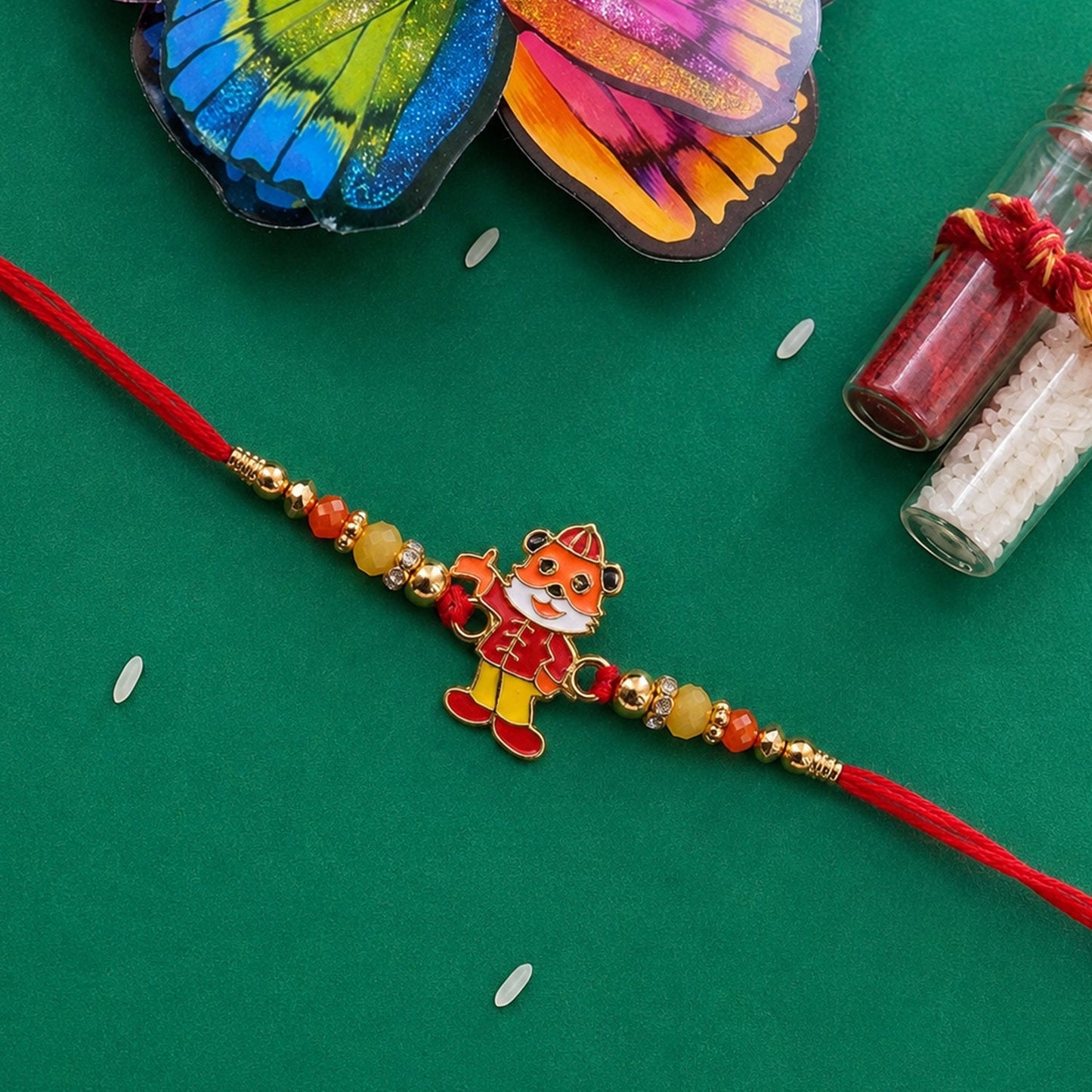 Brightly colored designer rakhi tied on wrist