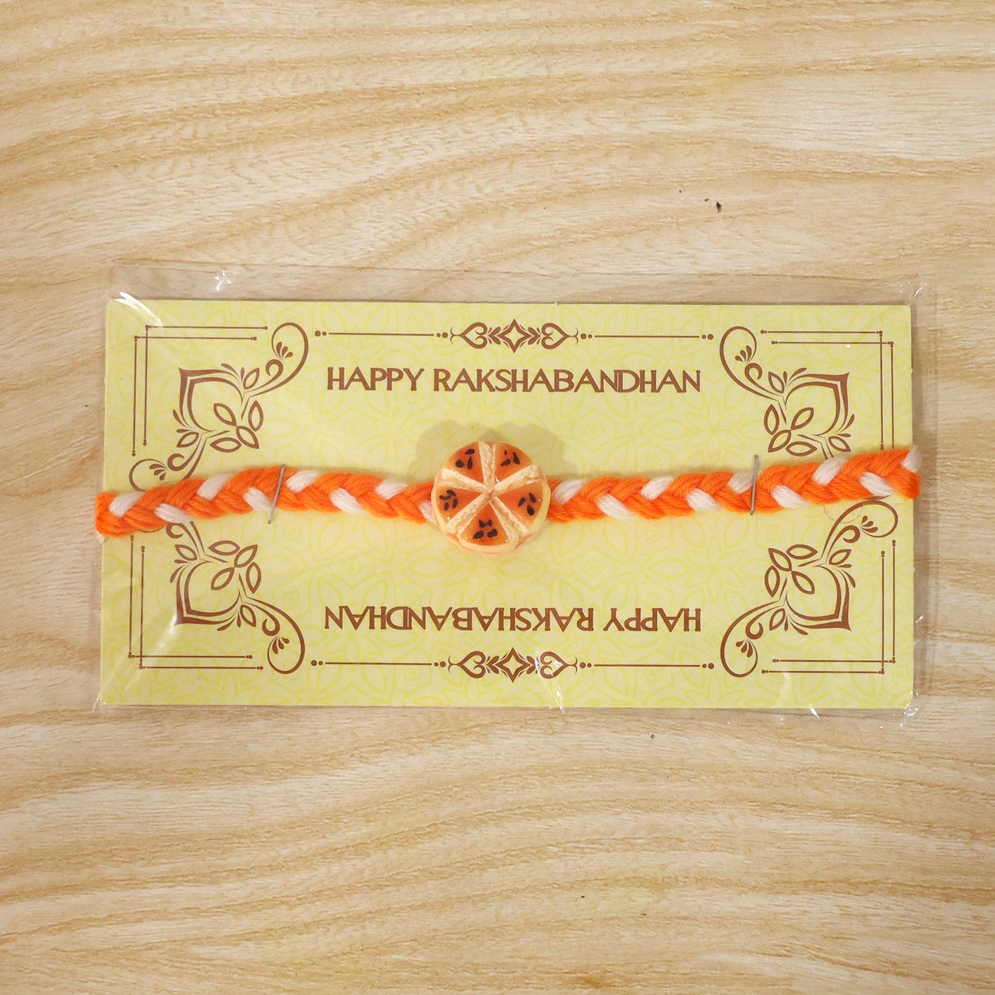Orange Slice Charm Rakhi packaging display