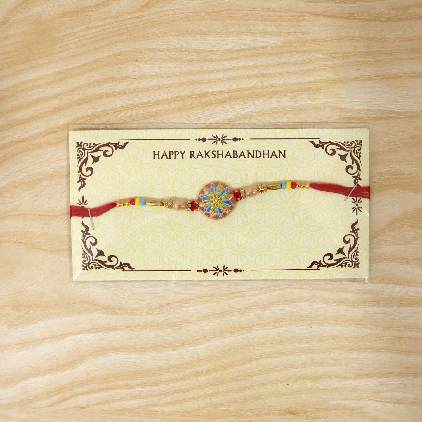 Elegant designer rakhi featuring meenakari charm and beads