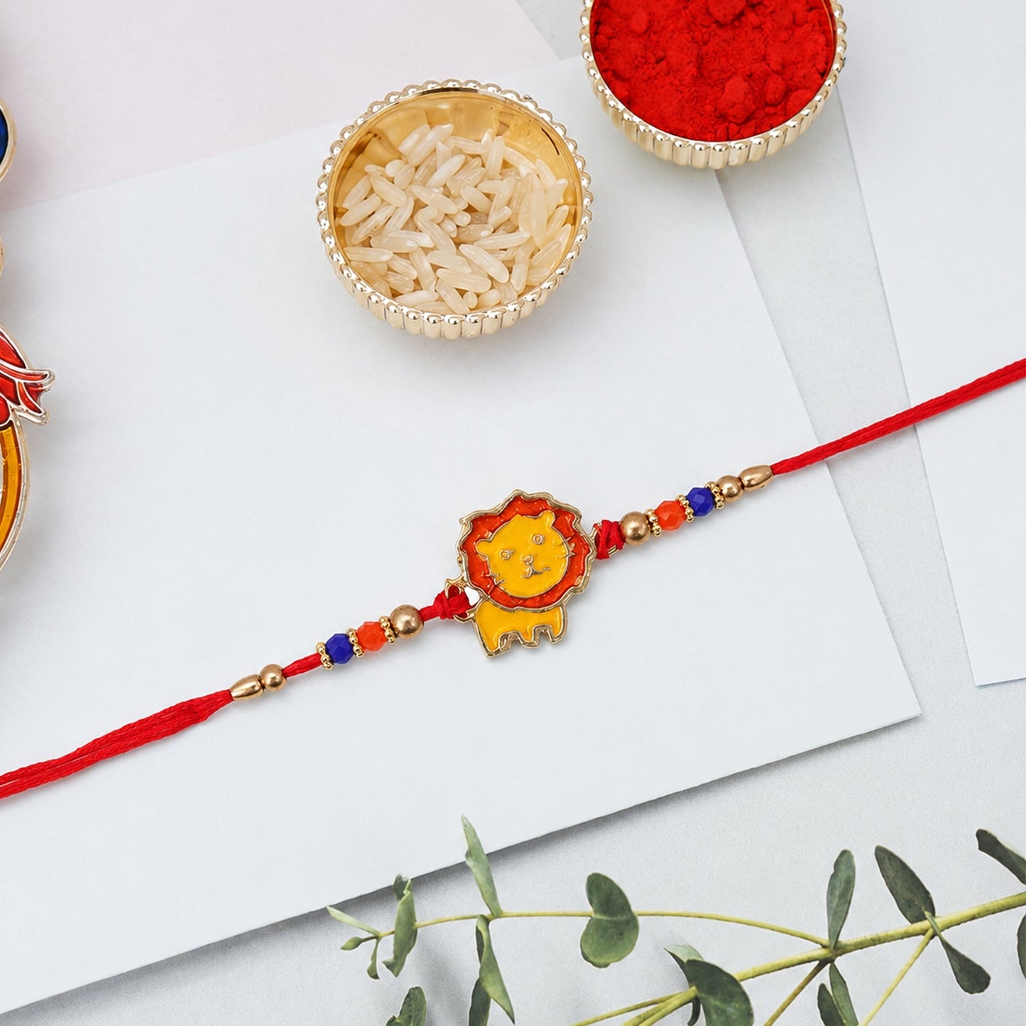 Top view of lion charm rakhi with thread