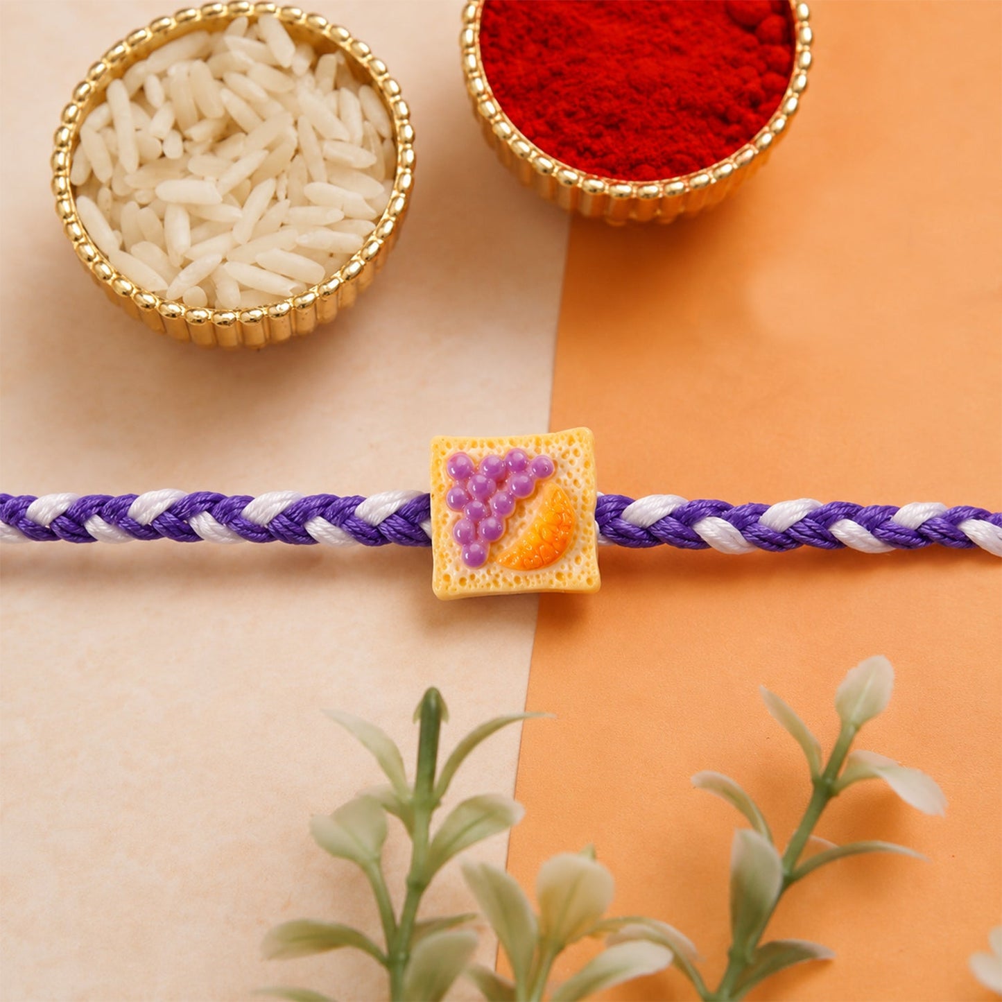 Close-up of Cute Fruit Toast Charm on braided rajhi thread