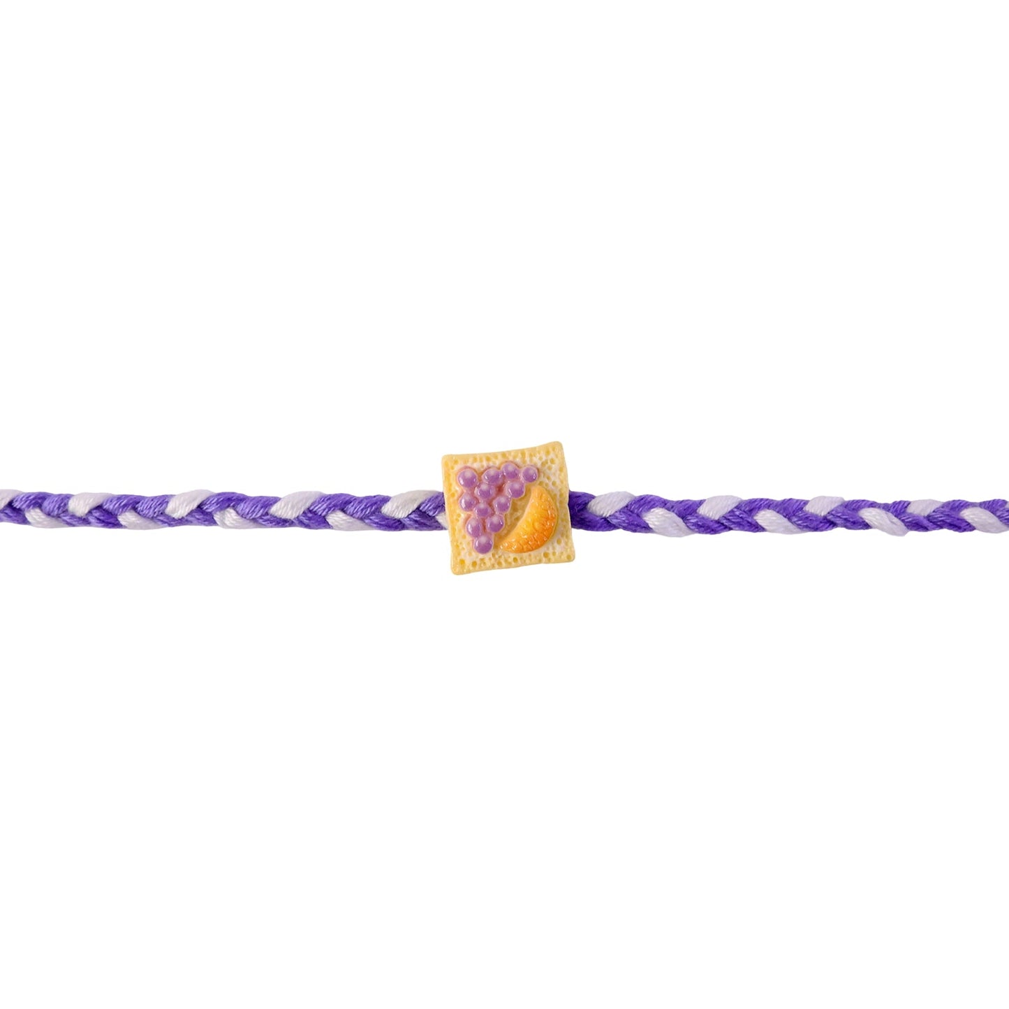 Colorful braided rakhi with fruit toast charm detail