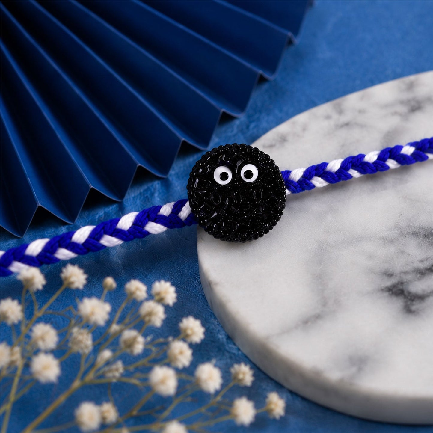 Rakhi thread detail with cookie eyes charm