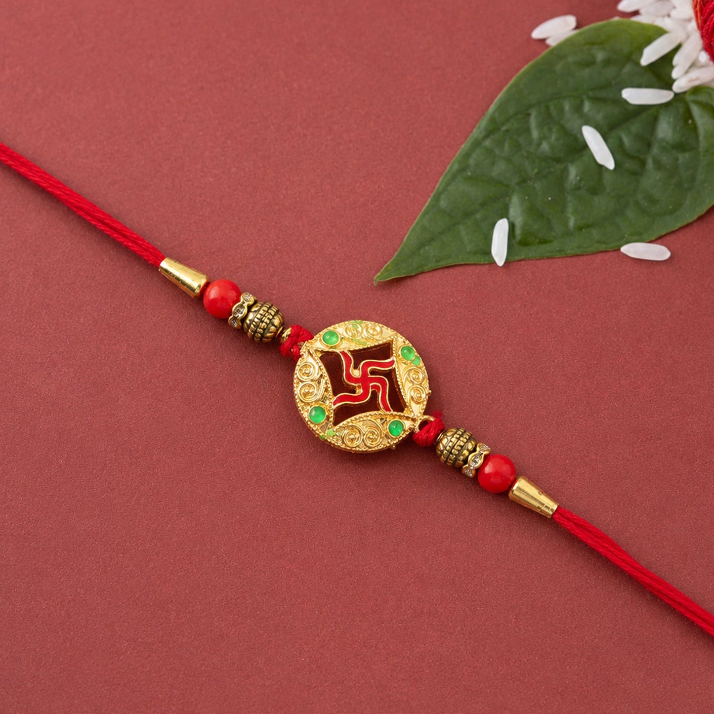 Golden charm rakhi tied with colorful threads