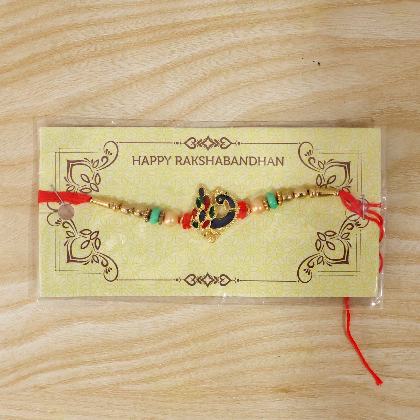 Festive Raksha Bandhan Rakhi with peacock charm and beads