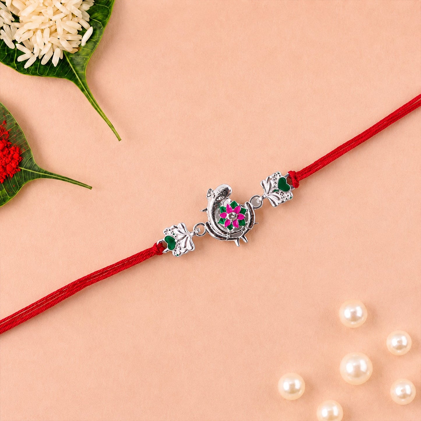 Silver Peacock Flower Heart Rakhi side view showing dori