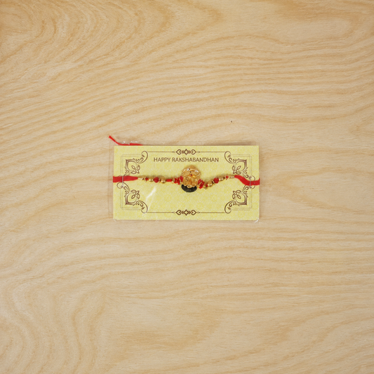 Golden Divine Face Charm Rakhi with pearl beads - top view