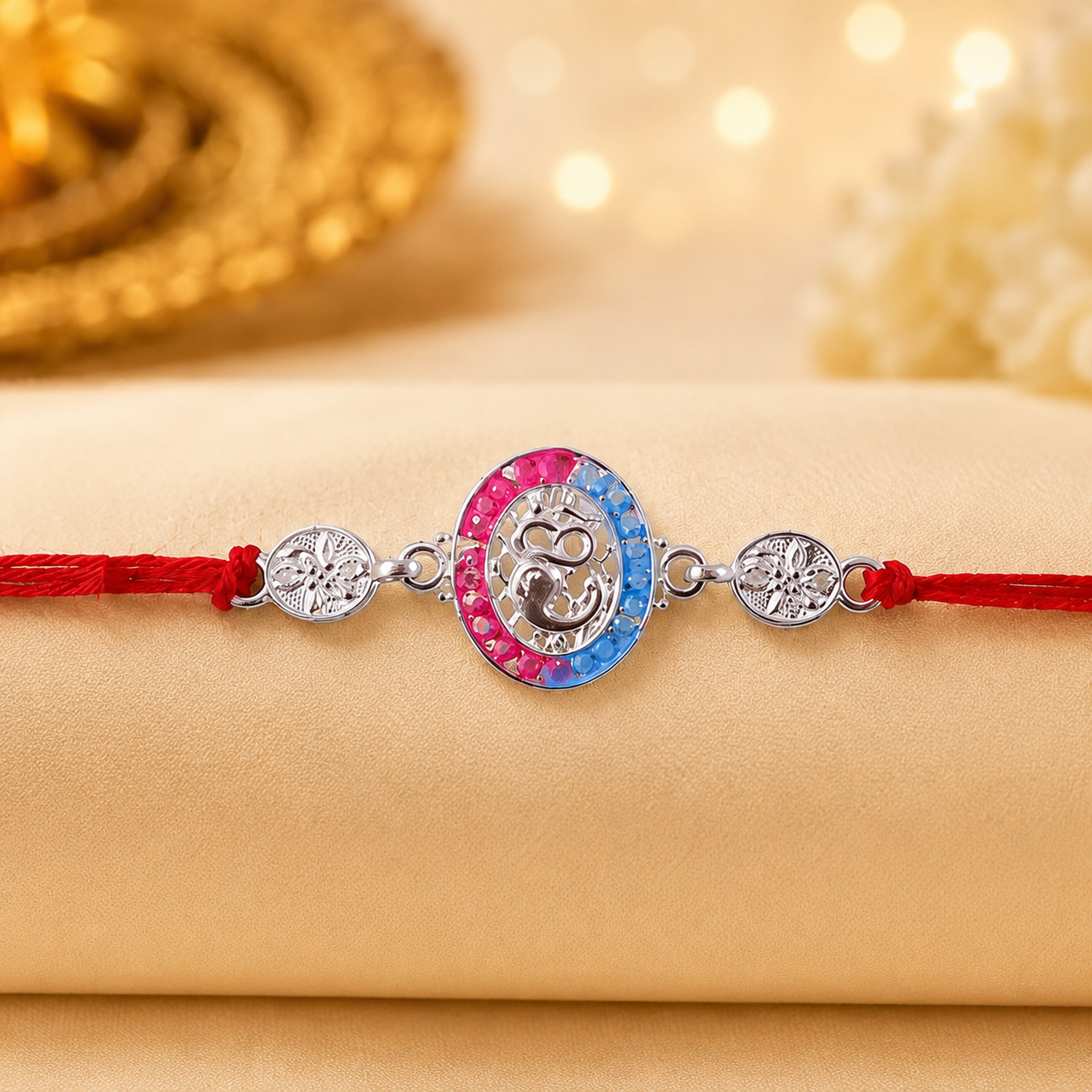 Silver charm rakhi showing detailed design and thread