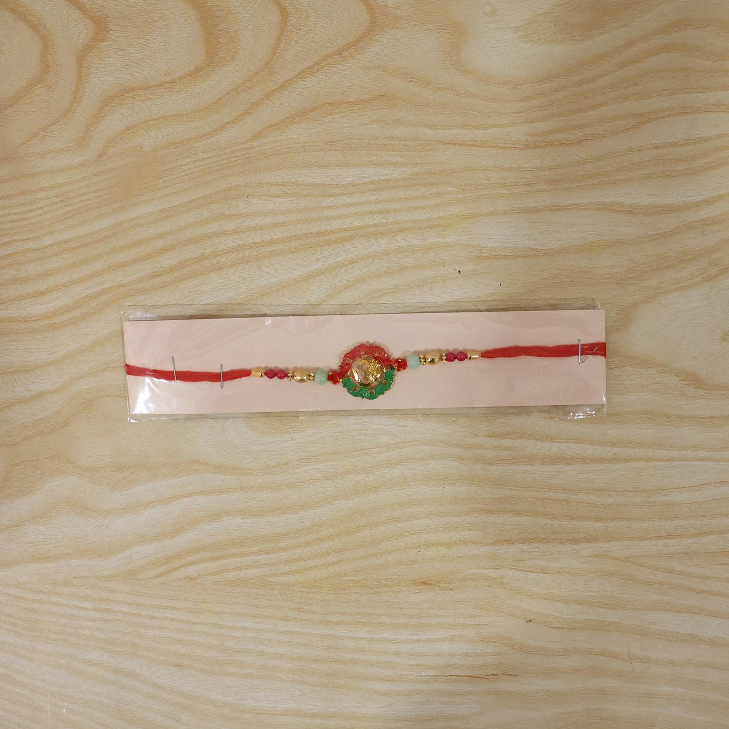 Traditional Golden Om Rakhi with elegant beads