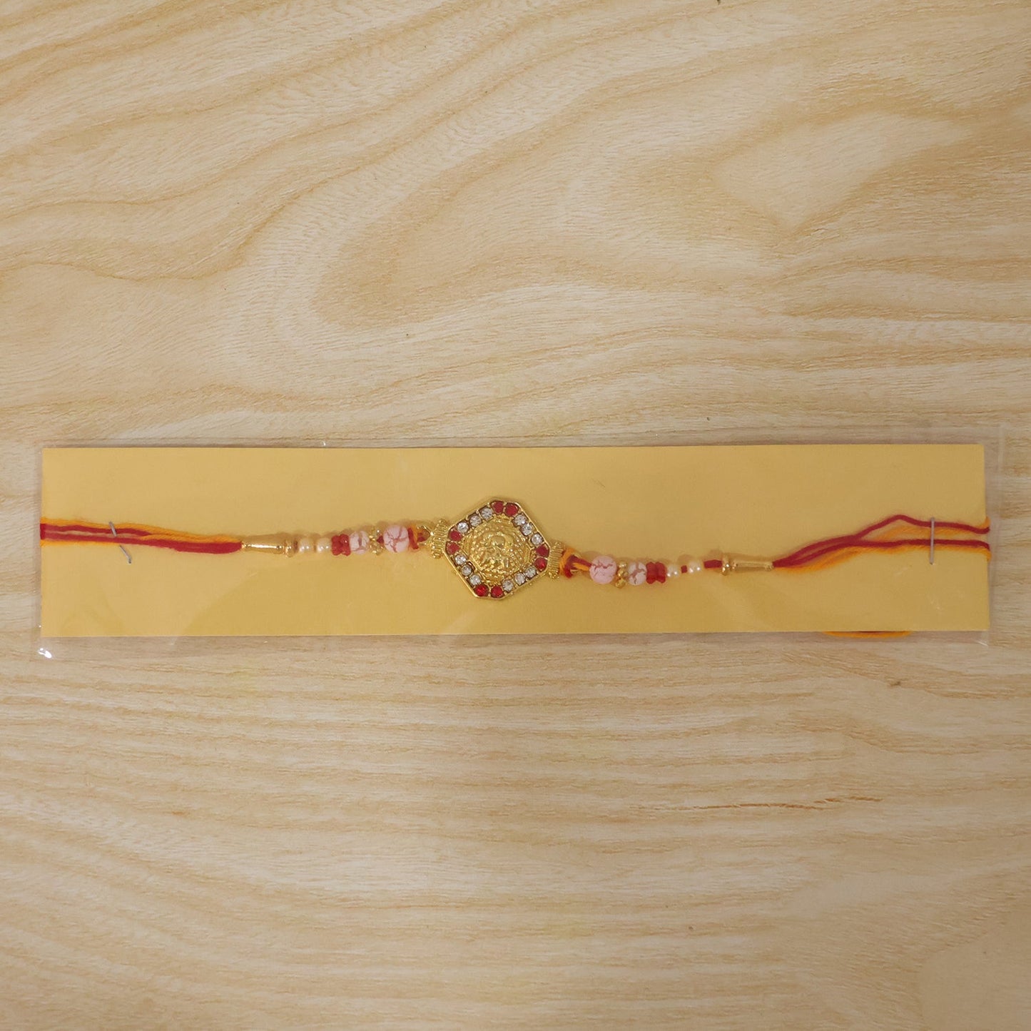 Goddess Lakshmi Rakhi with Red & White Stones