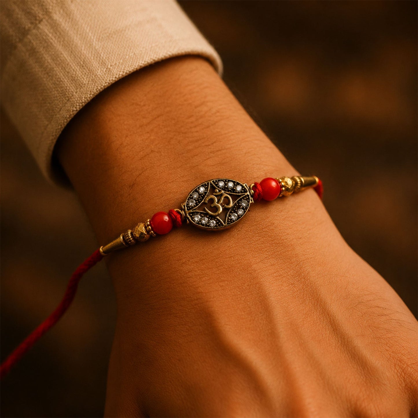 Antique Golden 'Om' Oval Rakhi