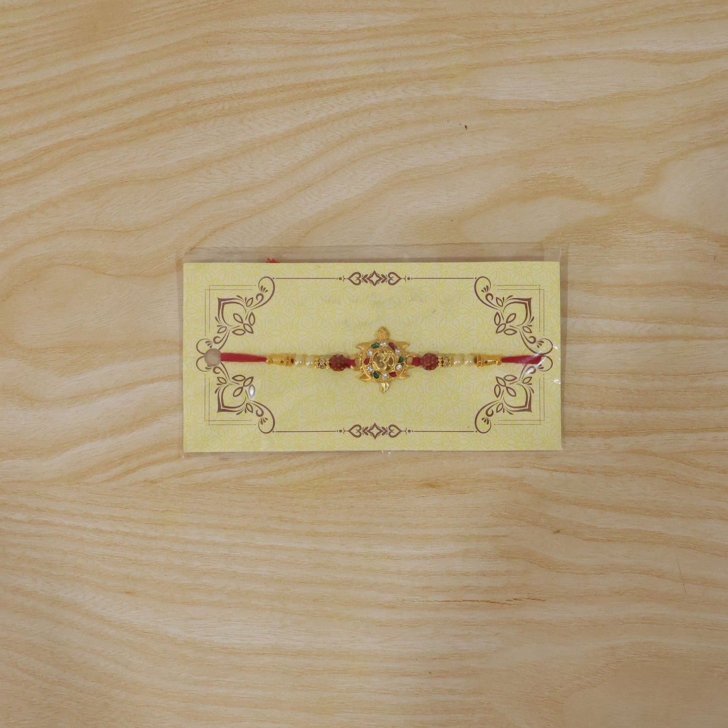 Auspicious Golden Tortoise Om Rakhi with Meenakari & Rudraksha Beads for Brother