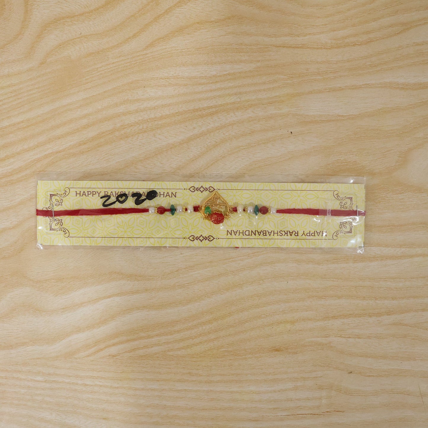 Golden Shree Krishna Rakhi with Pearls & Beads for Beloved Brother