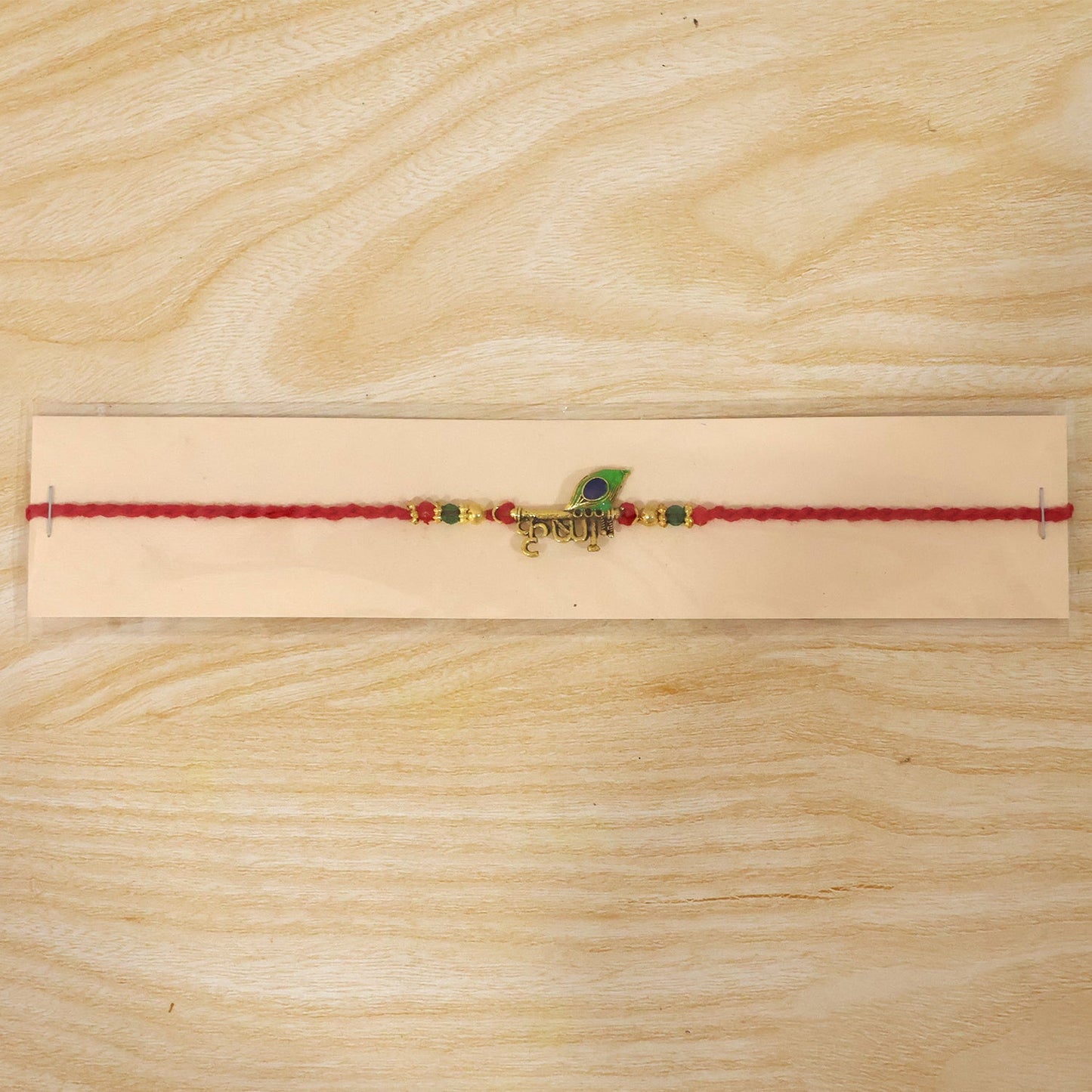Lord Krishna Text Rakhi with Peacock Feather for Brother
