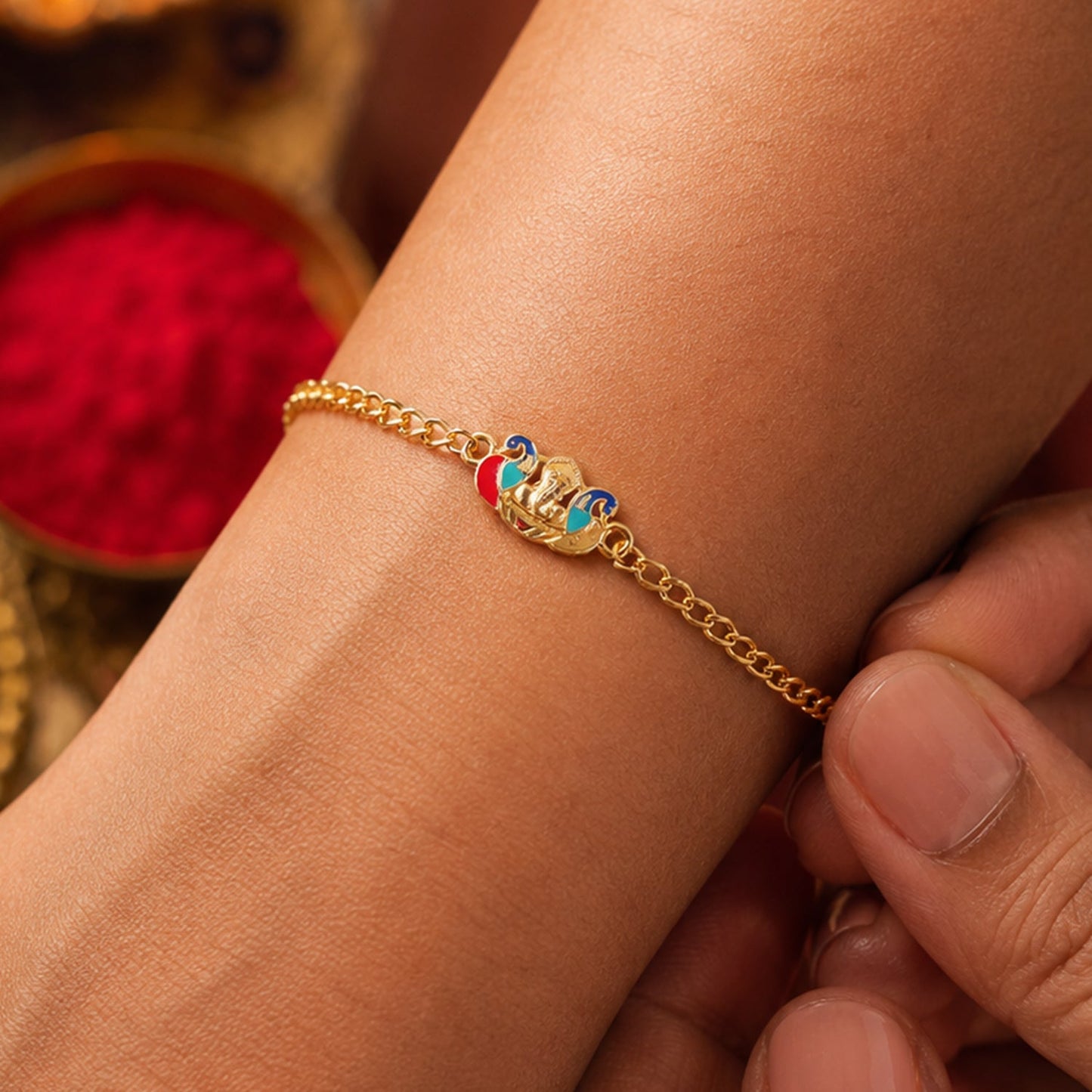 Top view of Peacock Ganesh rakhi bracelet showing thread details