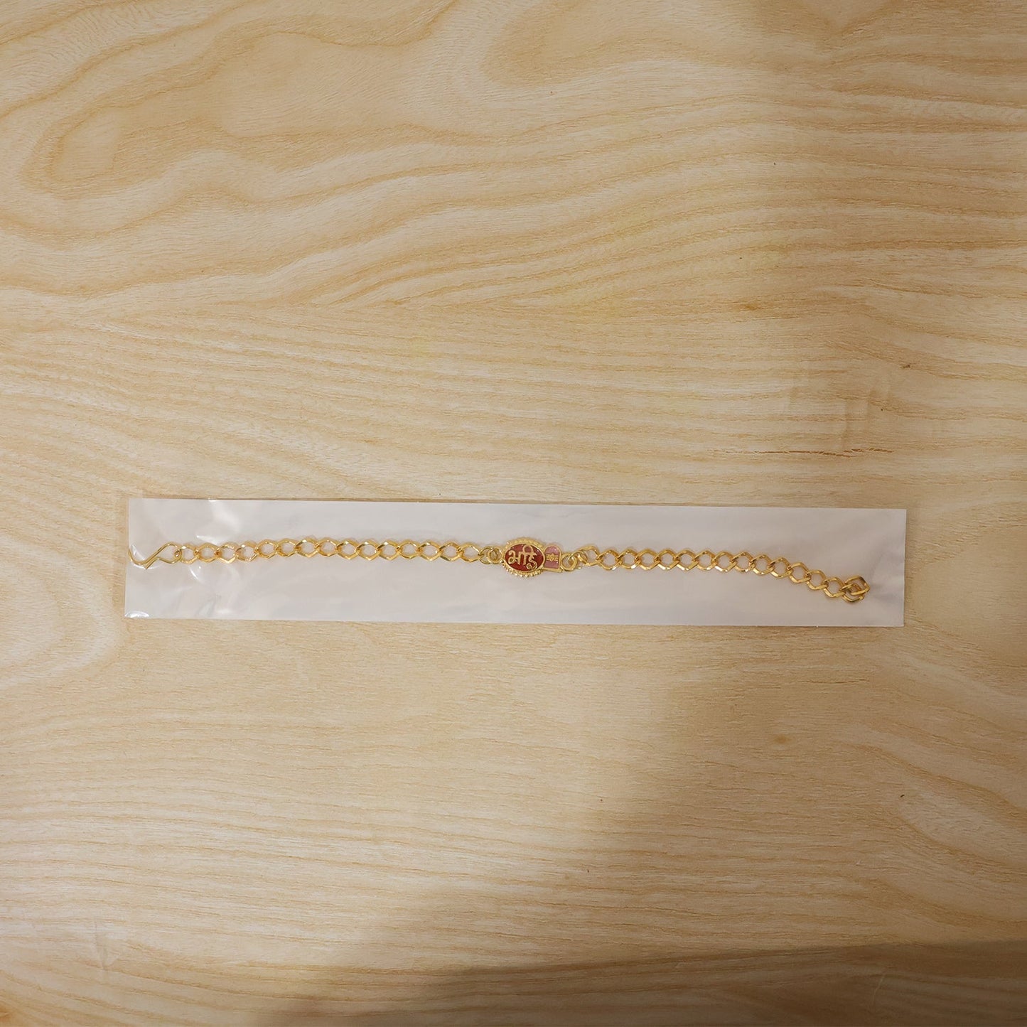 Decorative beads and thread detail on Bhai Red Enamel Rakhi