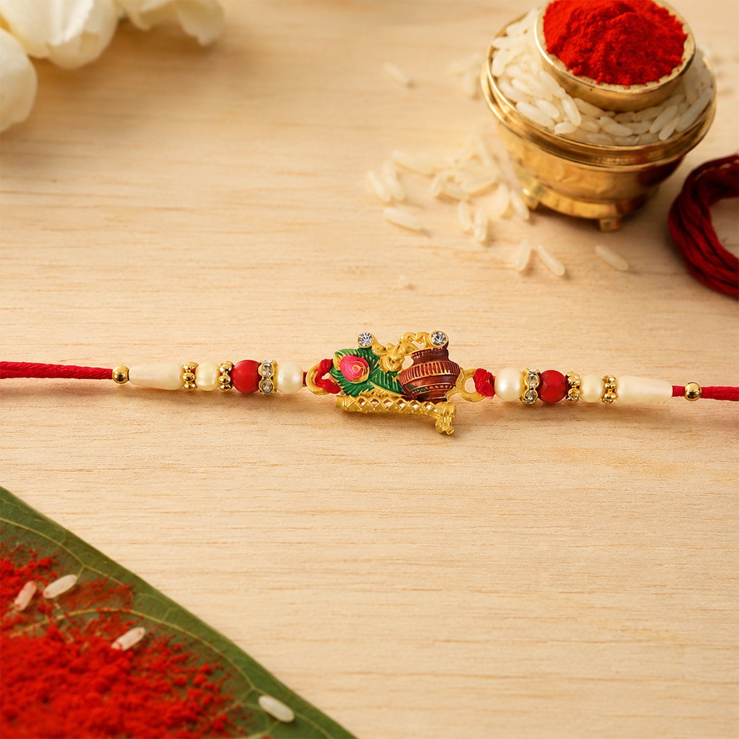 Krishna Matki Rakhi with Peacock Feather and Pearl Beads