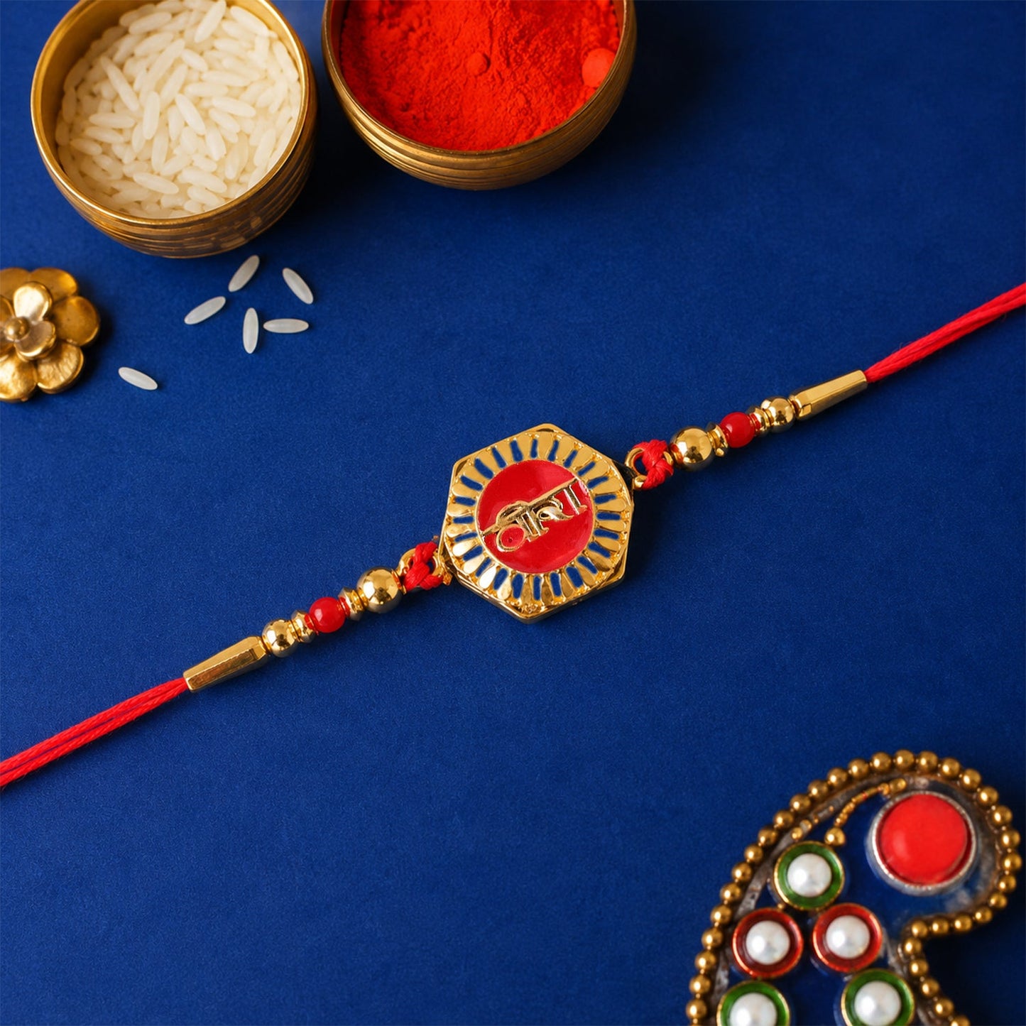 Side view of Veera Red Enamel Gold Tone Rakhi