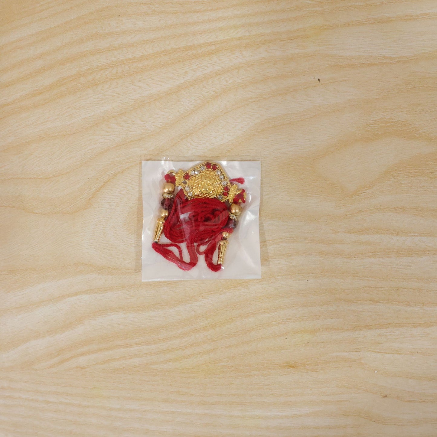 Lord Ganesha Red Enamel Gold Tone Rakhi
