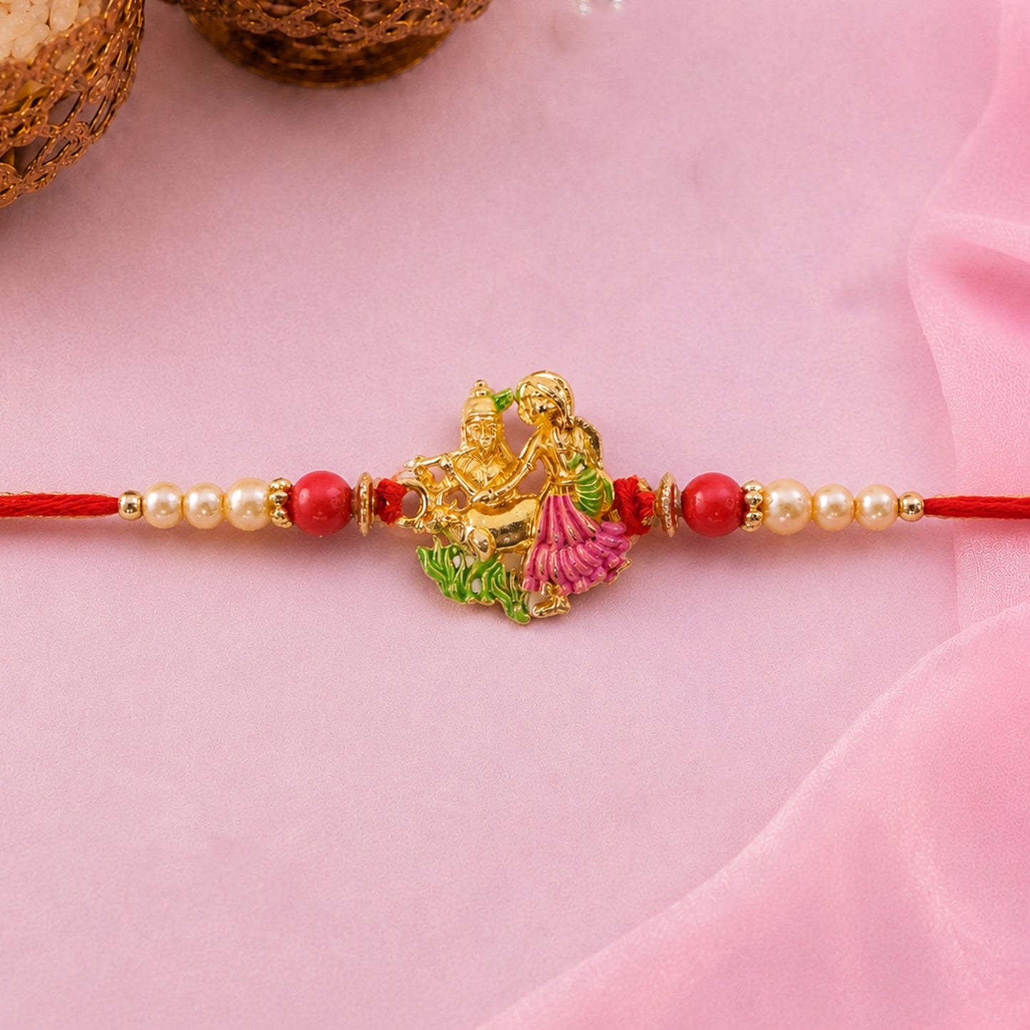 Close-up of Radha Krishna enamel rakhi design