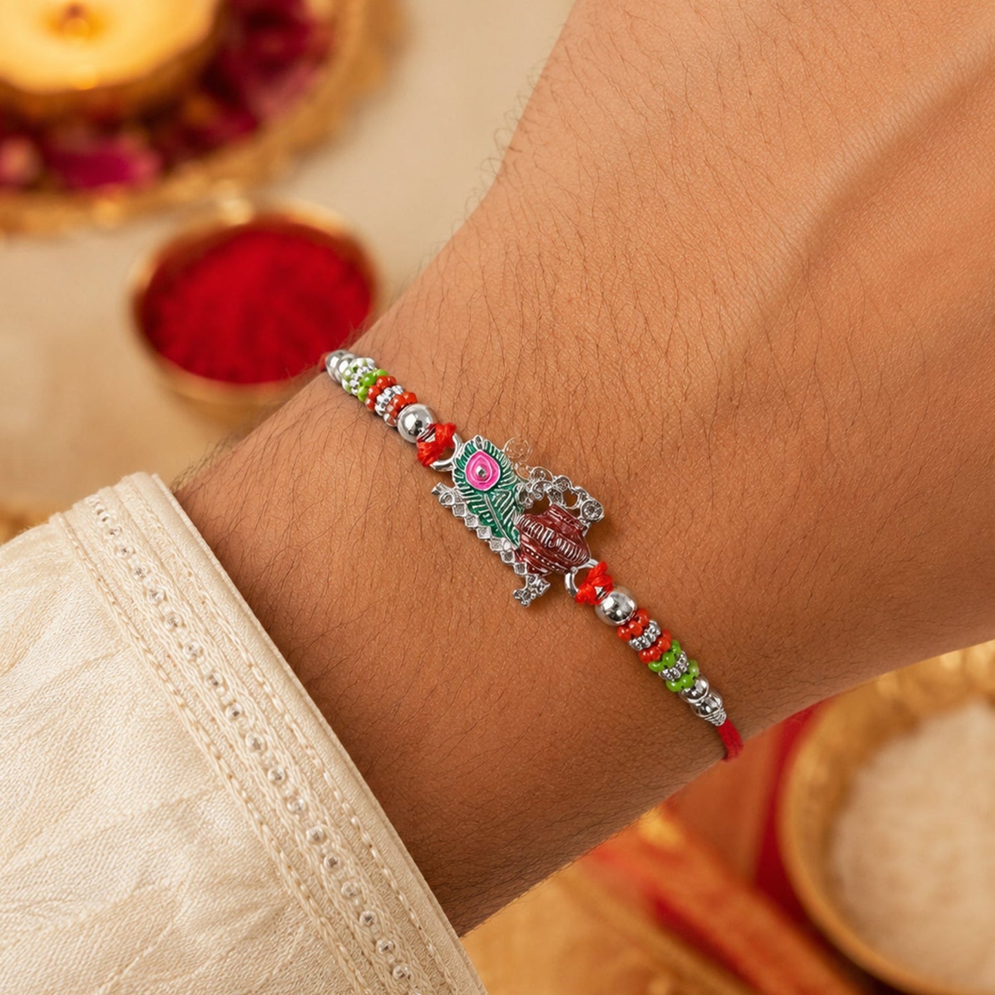 Close-up of Krishna Matki Rakhi with vibrant beads & feather