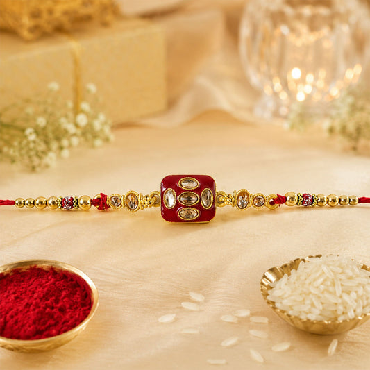 Square kundan multi-stone enamel charm rakhi for brother with pearl beads.