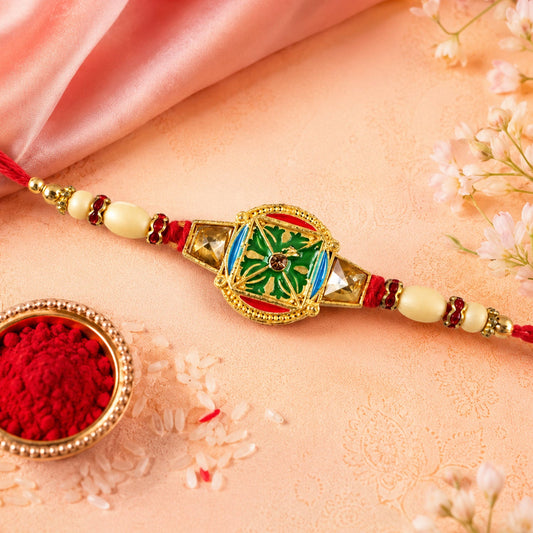 Kundan Meenakari Rakhi with a round charm and pearl beads.
