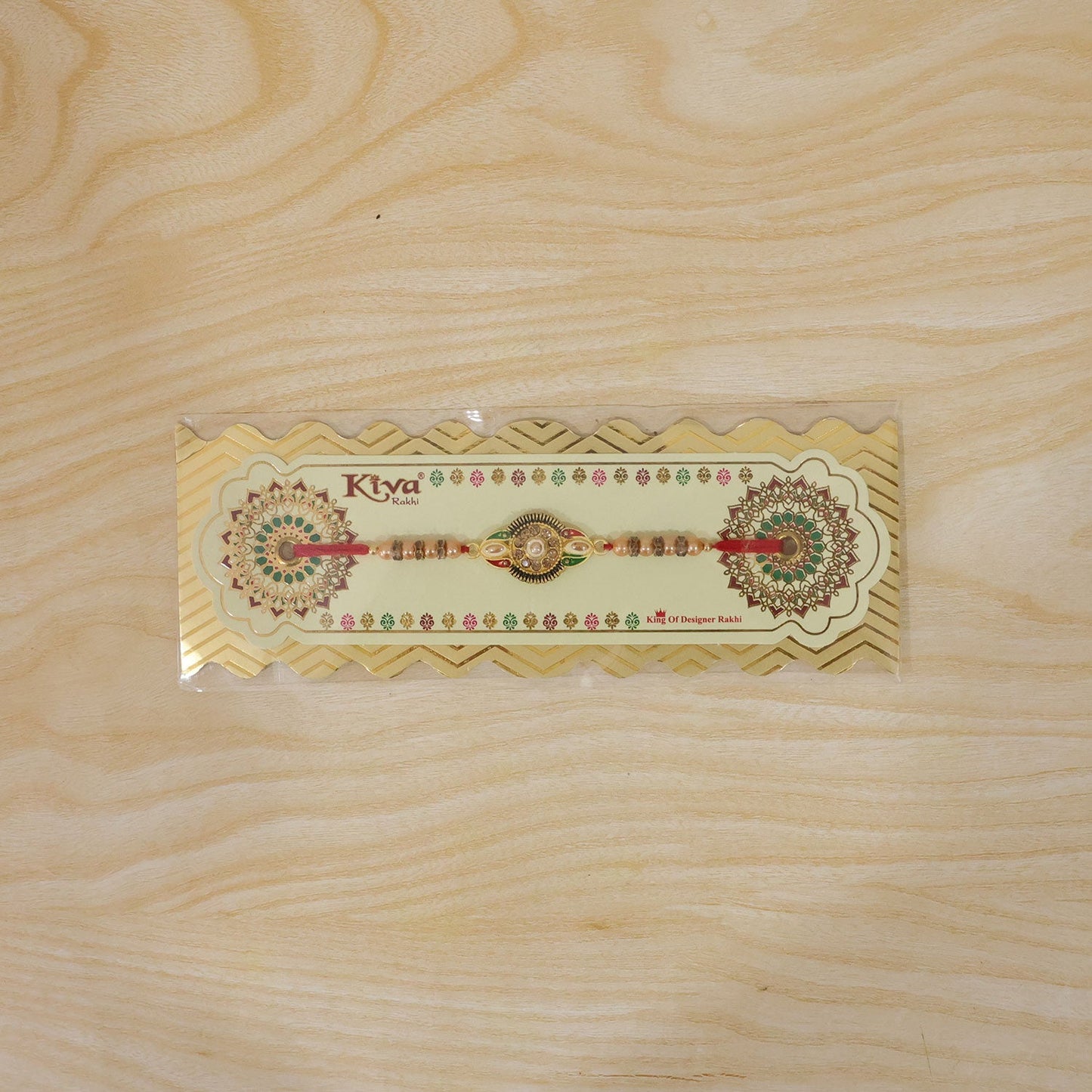 Hand wearing floral center designer rakhi with stone work