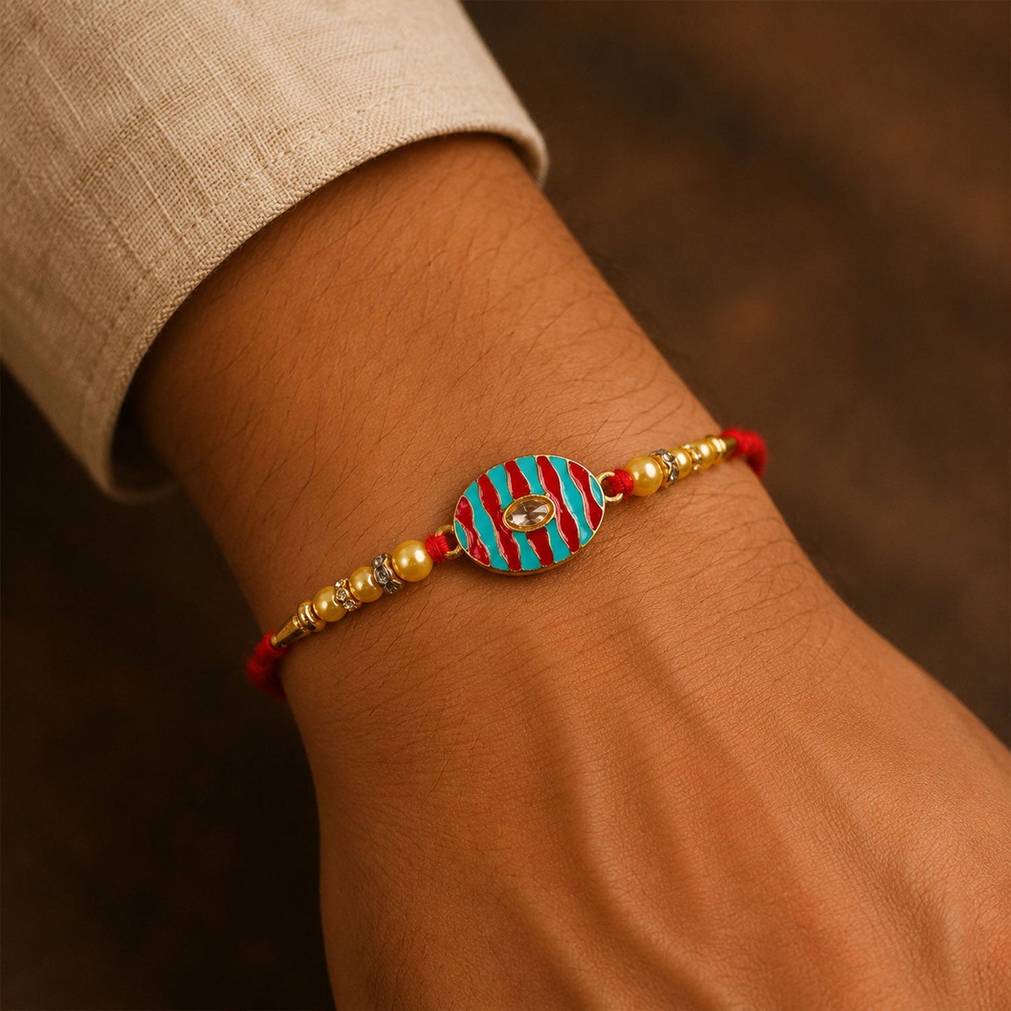Kundan Rakhi with pearl beads tied on a brother's wrist for Raksha Bandhan.