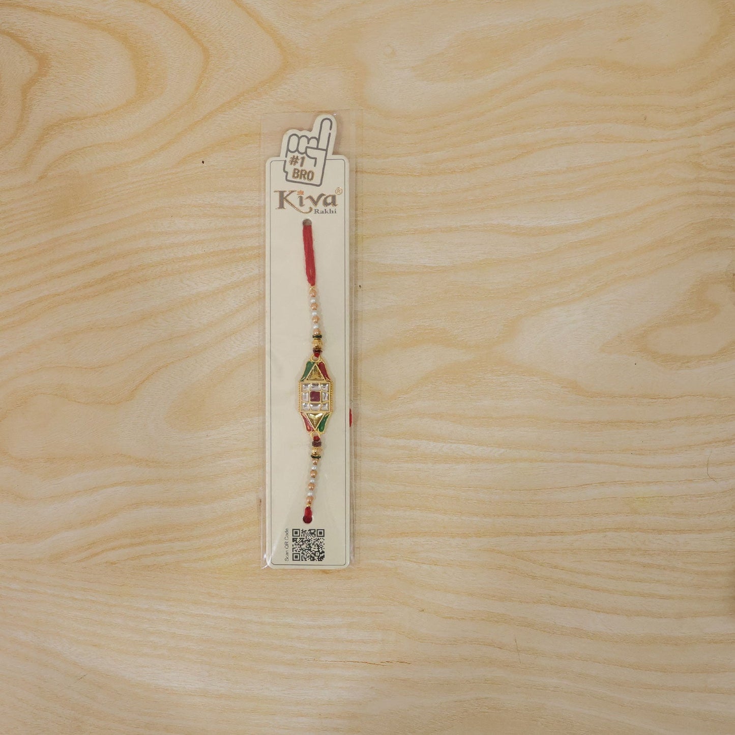 Full view of the Rakhi thread and charm, showcasing its overall design.