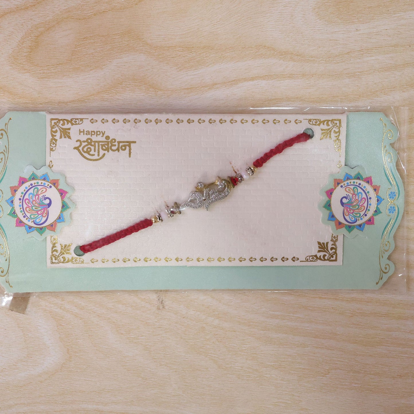 Religious Om Peacock Diamond Rakhi with Beadwork Rakhi for Brother