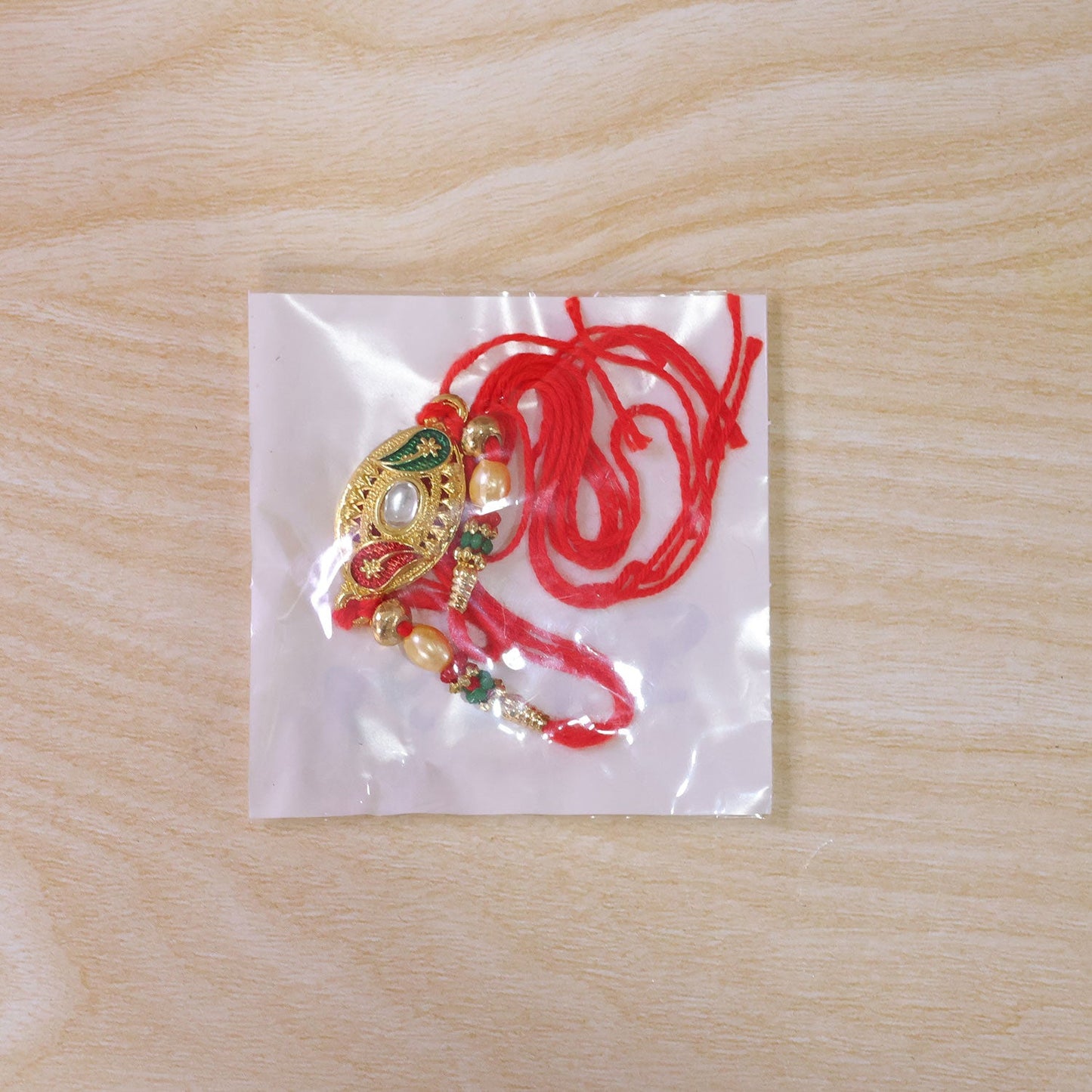 Golden Kundan Oval Rakhi with Meenakari & Pearls – Rakhi for Brother